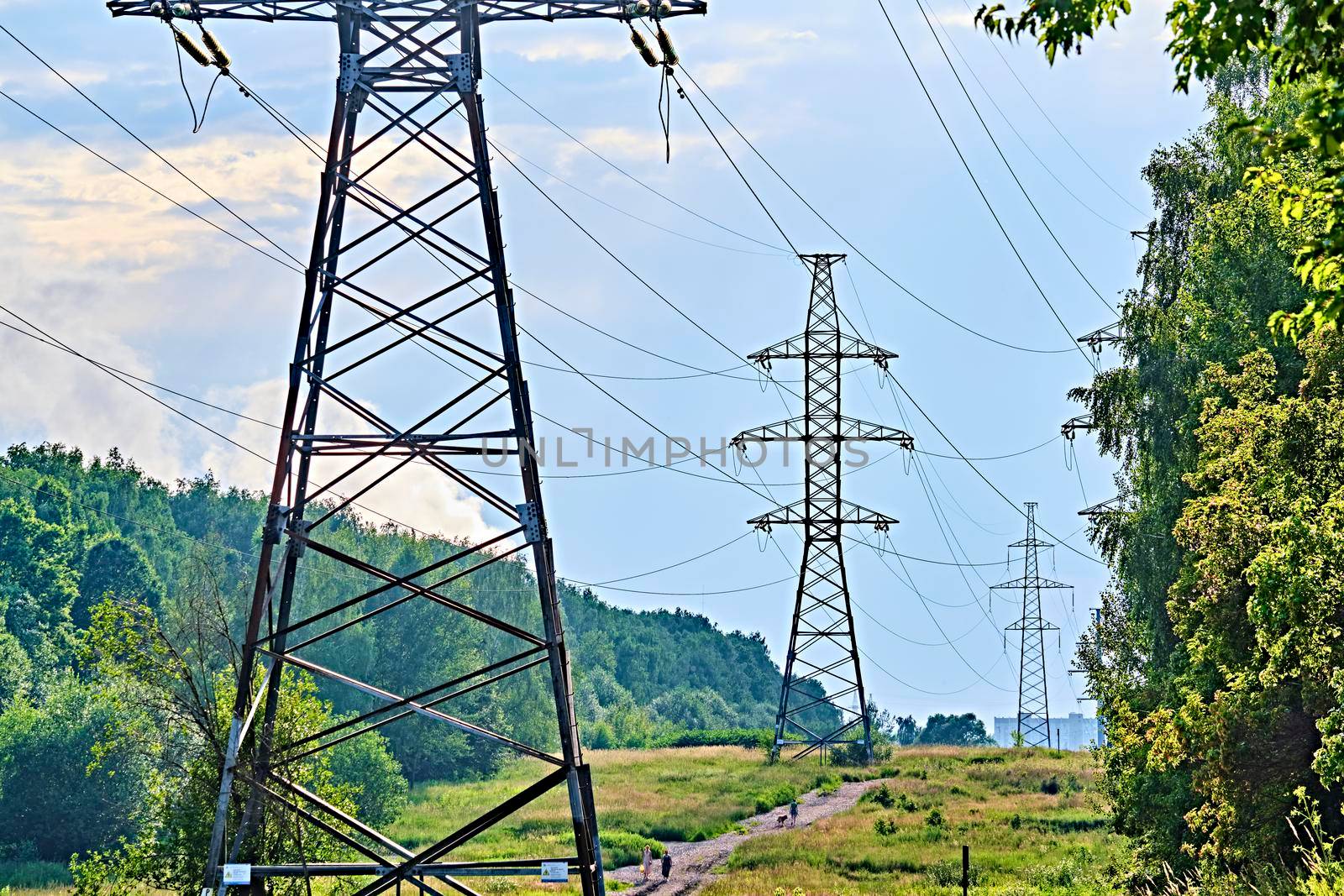 A long line of electrical transmission towers carrying high voltage lines.