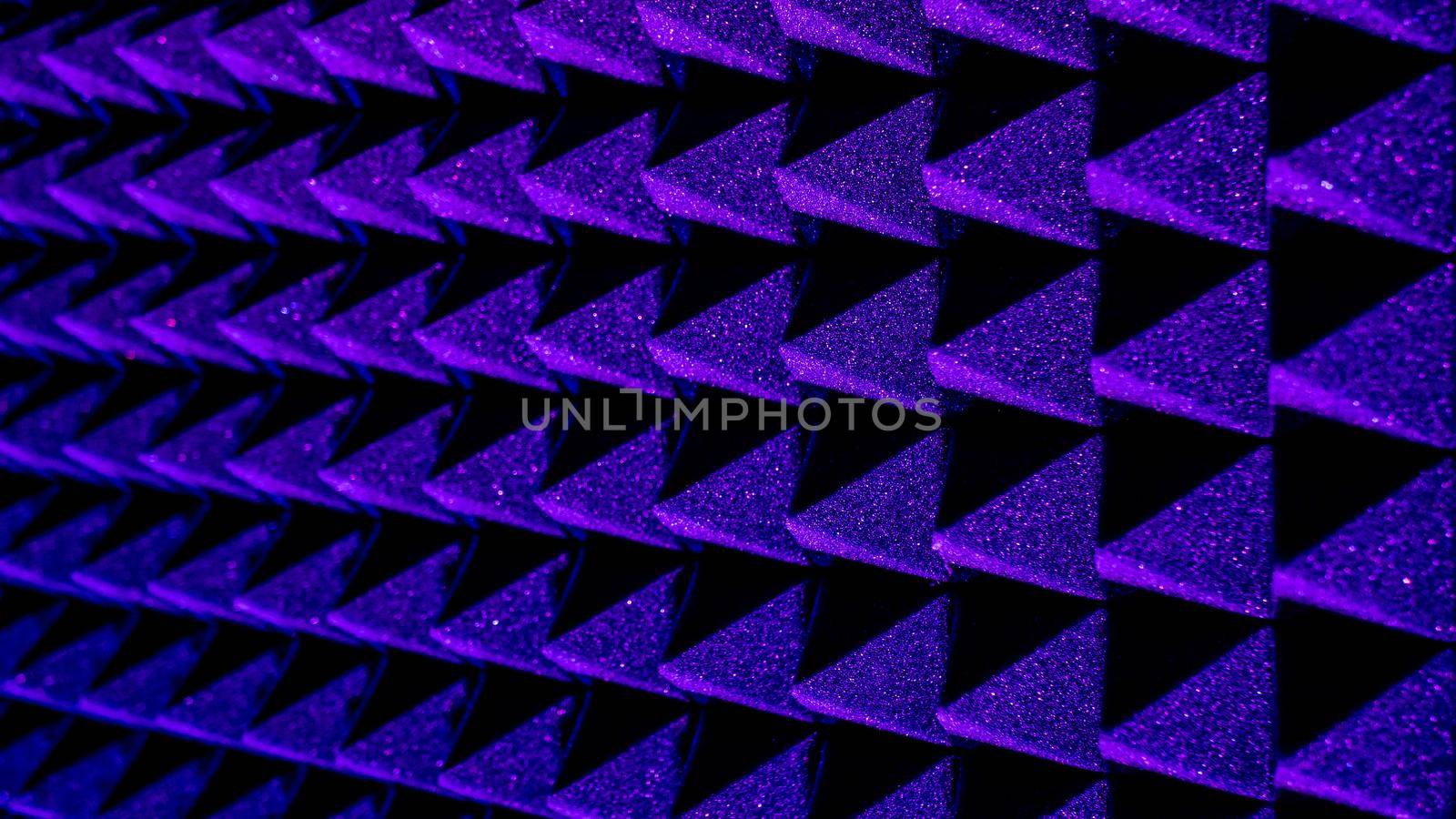 Background image of recording studio sound dampening acoustical foam.