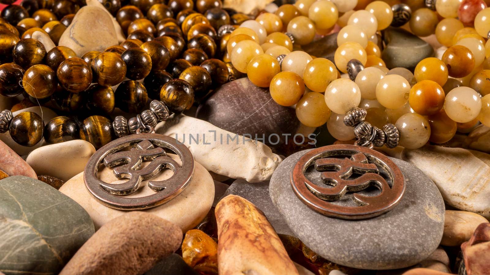 Buddhist prayer beads Mala lying on the sea rocks. close-up by lempro