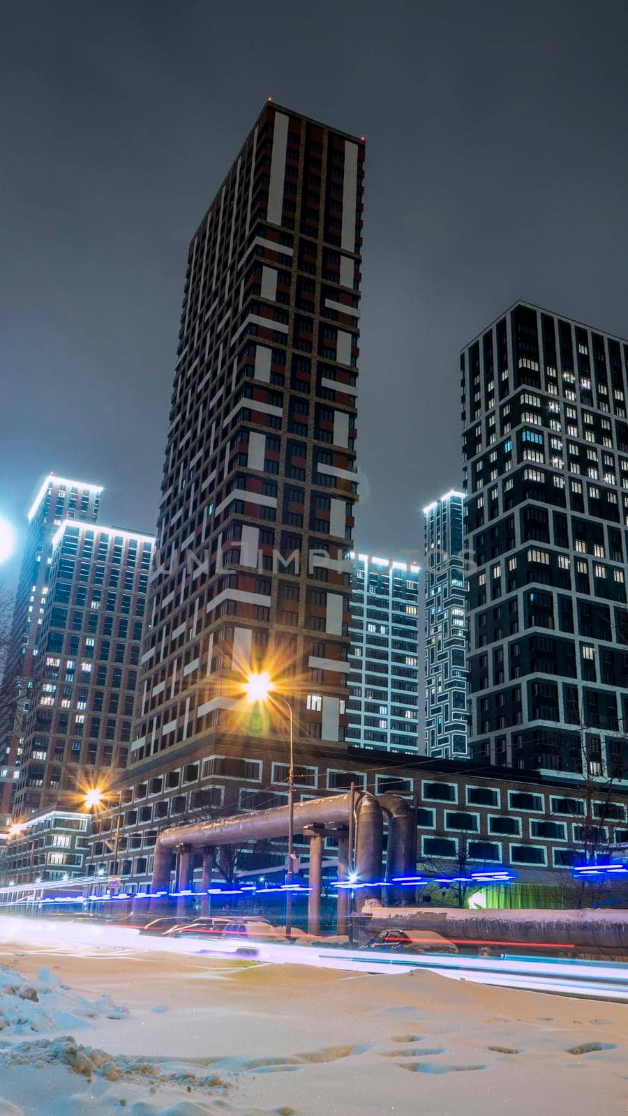 Bottom view of the facade of a new multi-storey residential building with baccos .the new Russian district. low light by lempro