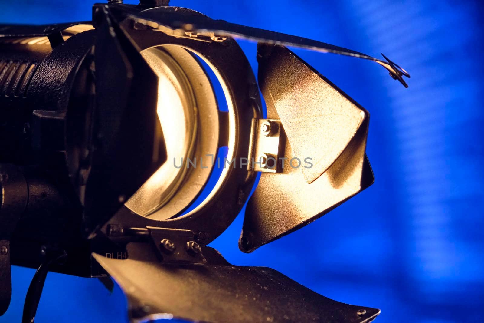 Close-up of a professional lighting fixture on a set or photographic studio. Concept of shooting a movie. color