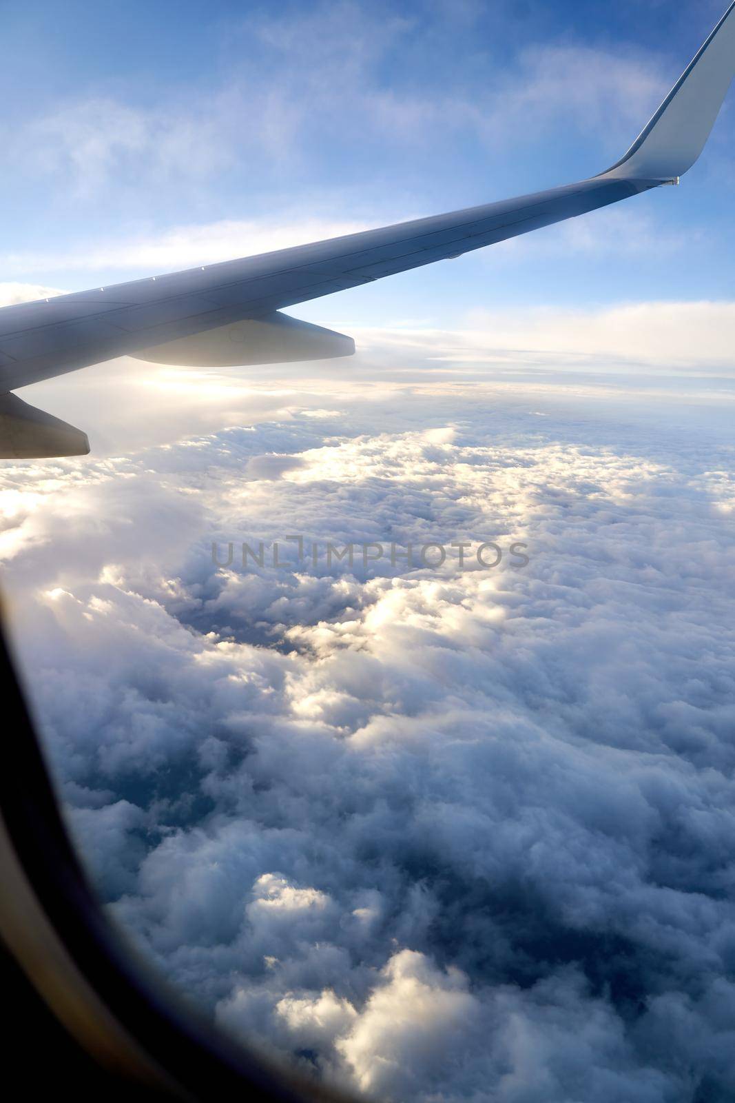 Clouds and sky as seen through window of an aircraft