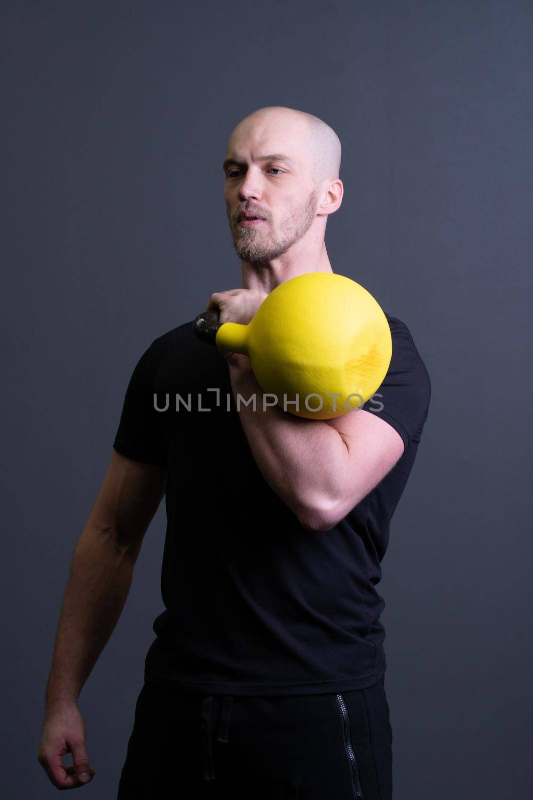 Guy with a yellow kettlebell gym anonymous yellow strength, from motivation lifestyle for men and floor sportswear, southeast activity. Guy down health, circuit hiit