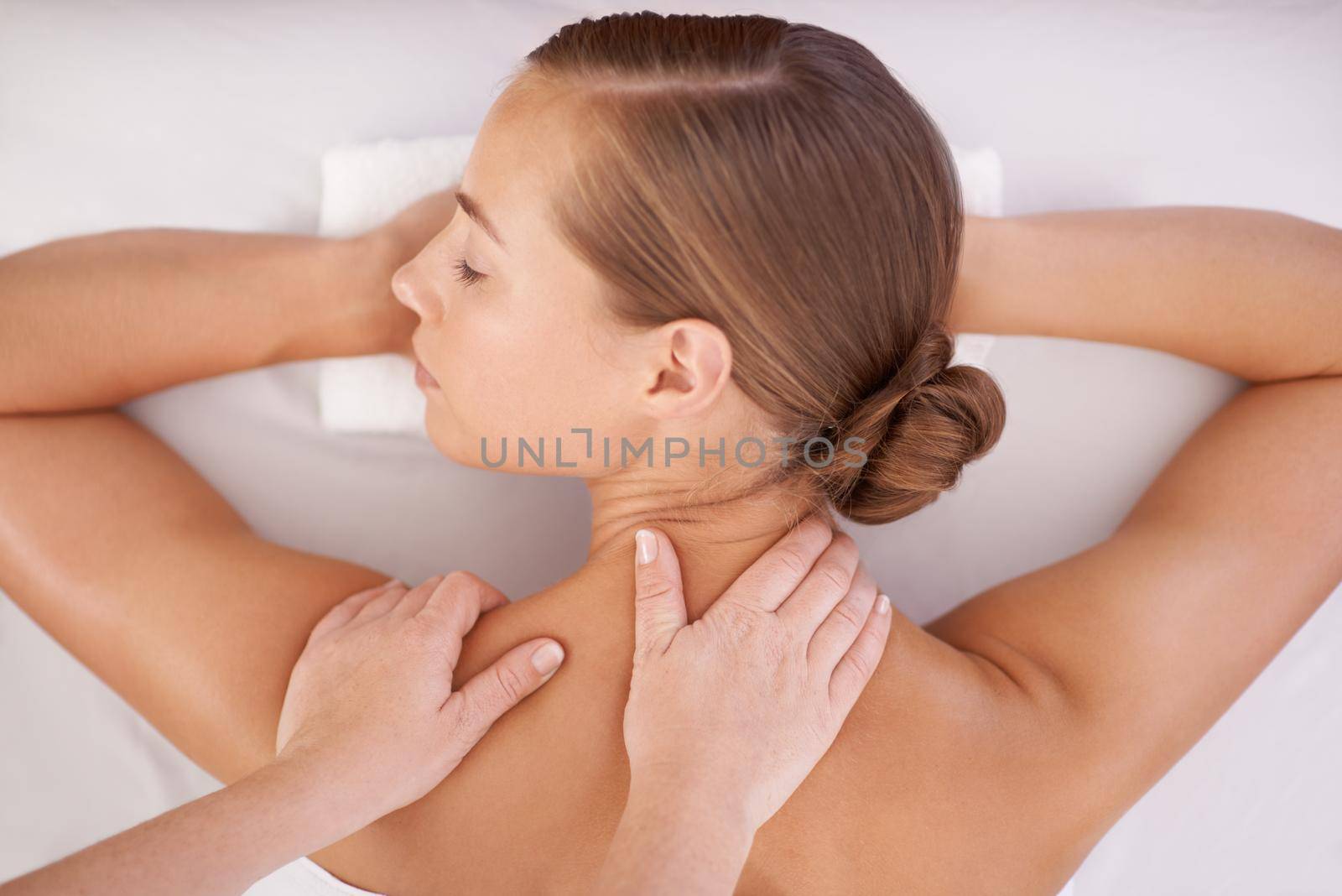 A young woman on a massage table in a spa.