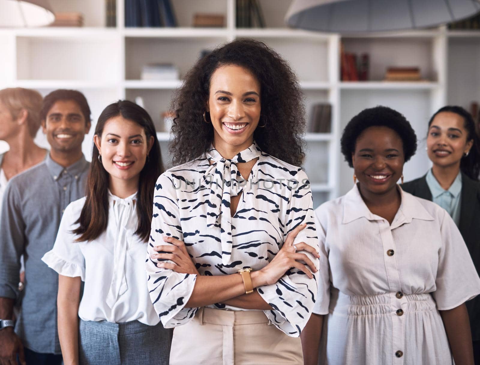 Portrait of a diverse group of businesspeople standing together in an office.