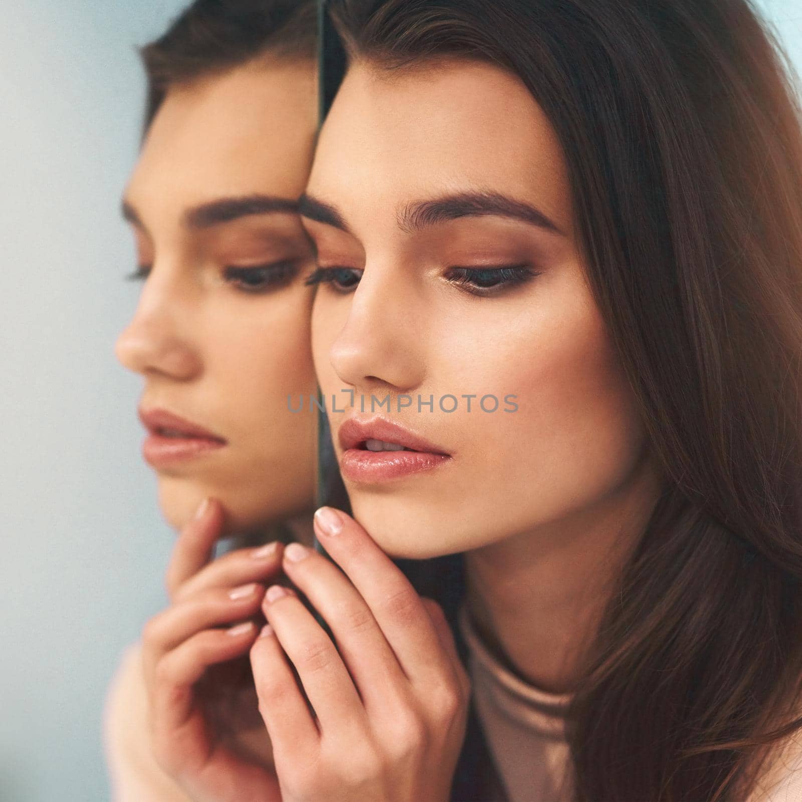 The mirror does not define your beauty. Shot of a beautiful young woman leaning against a mirror. by YuriArcurs