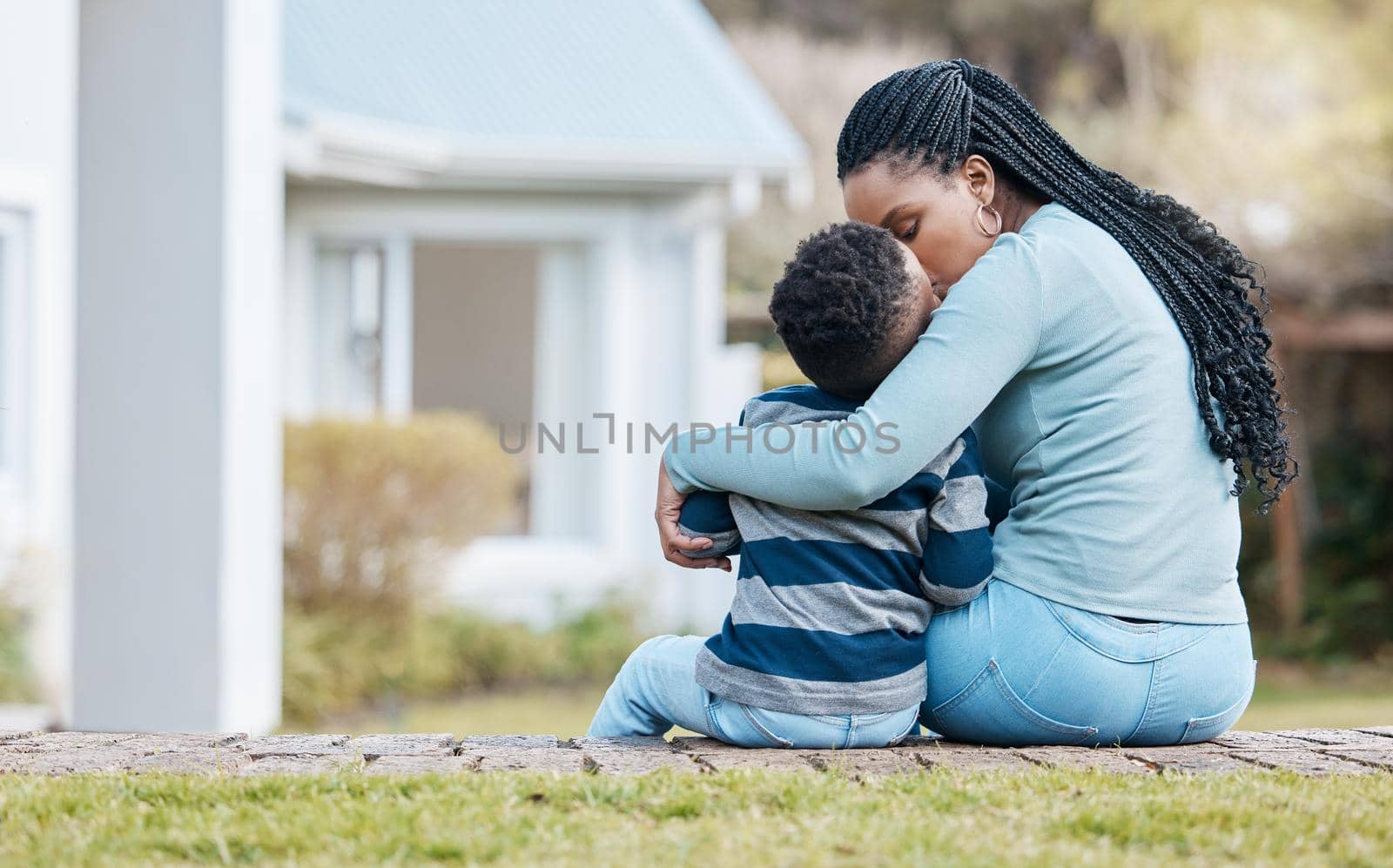 Shot of a young mother sitting and bonding with her son in the garden.