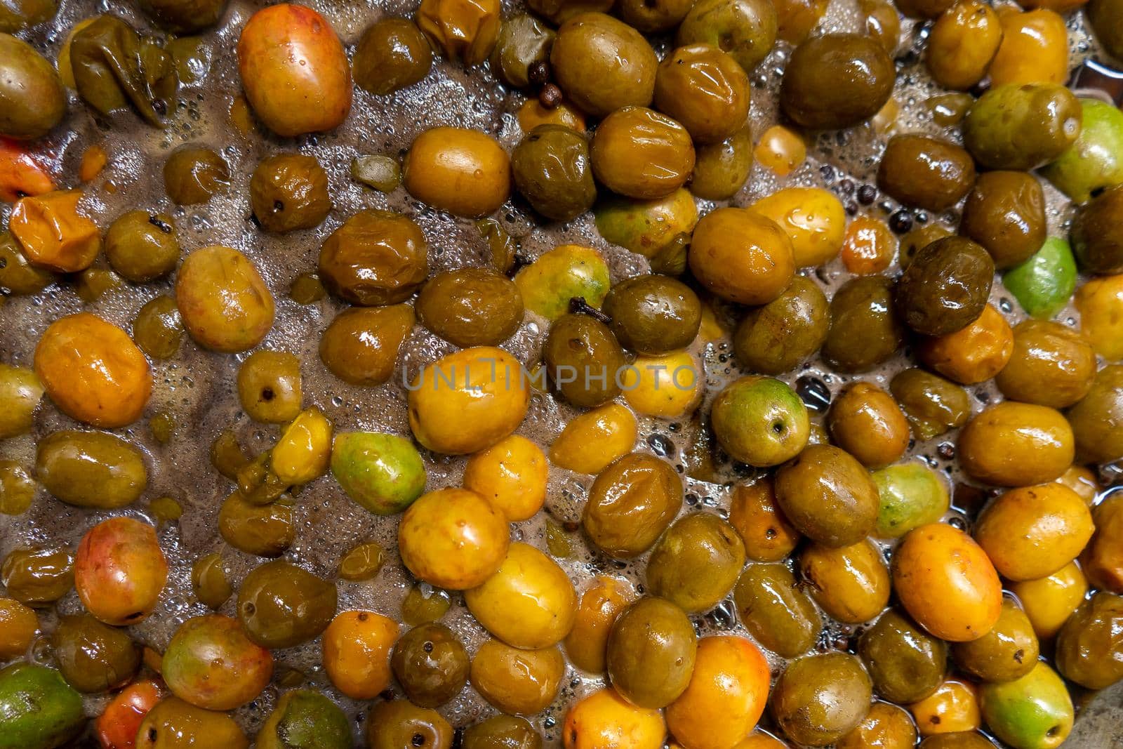 Boiling jocotes for syrup in a large metal pot. A tradition from Nicaragua and Central America during Holy Week and Easter. Top view.