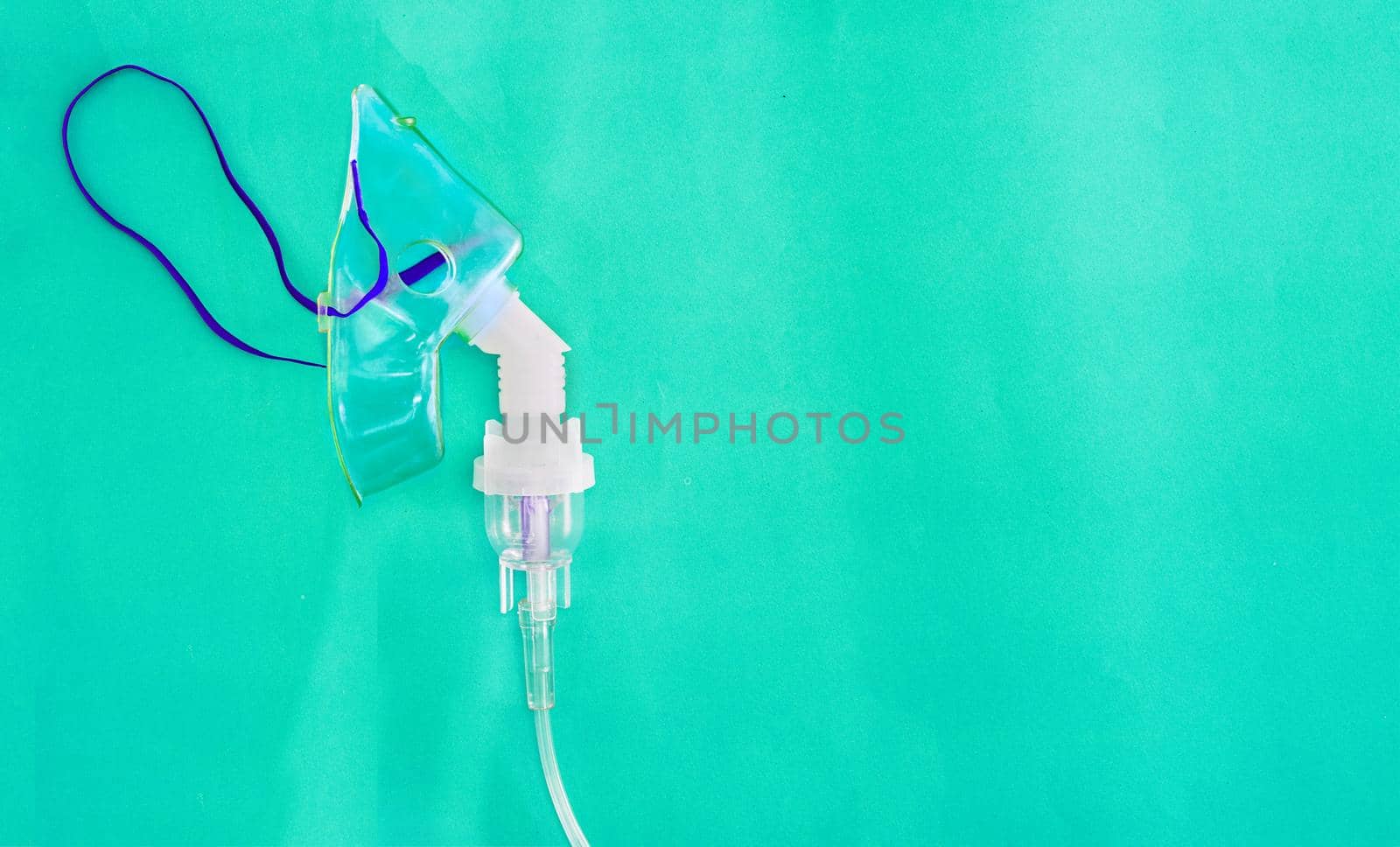 adult nabulizer mask on green background in asthma treatment care concept with copy space