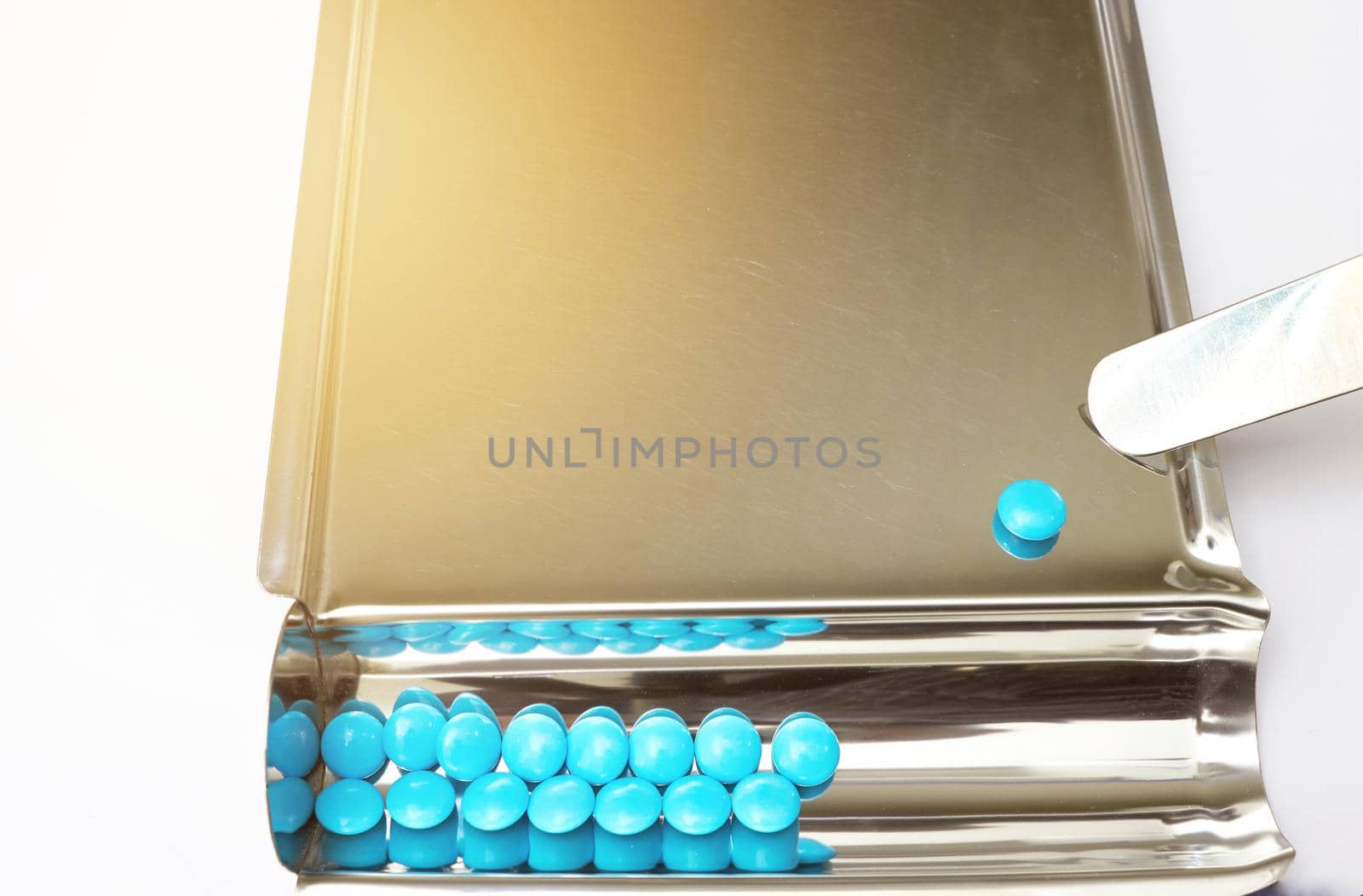 blue coated tablet on tray in drugstore business and healthcare concept with copy space