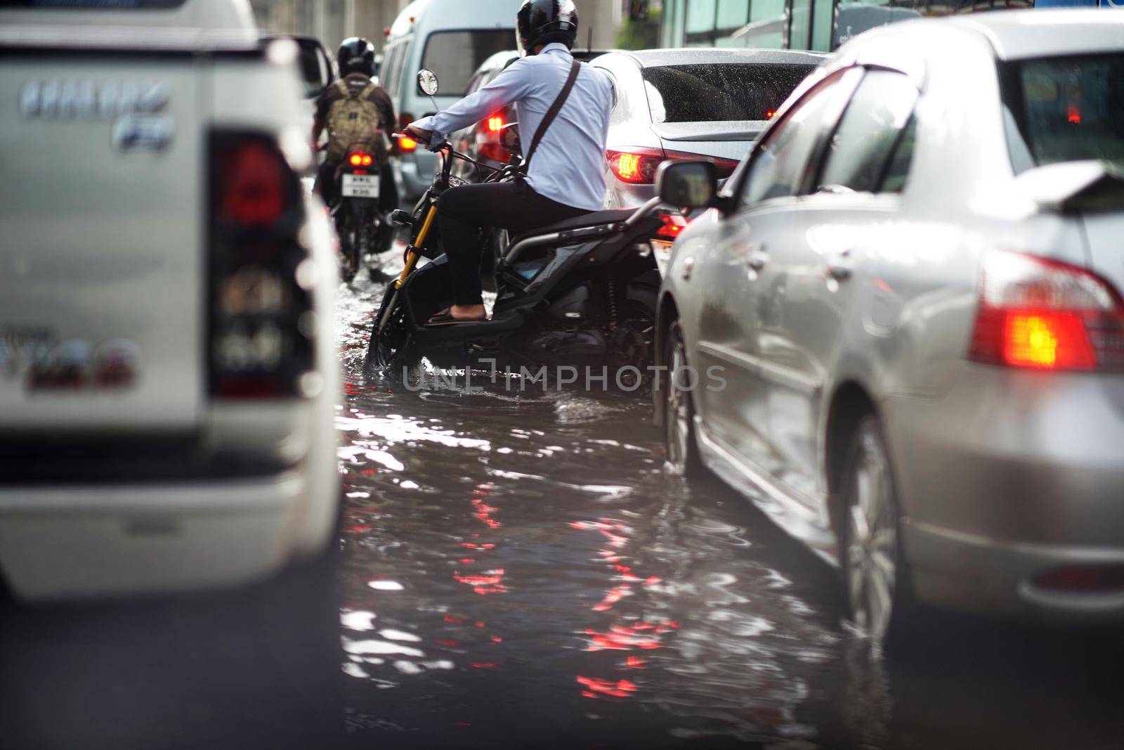 Bangkok ,Thailand ,May 16 ,2019-Flood on public road and motorcycles and minitruck in traffic jam