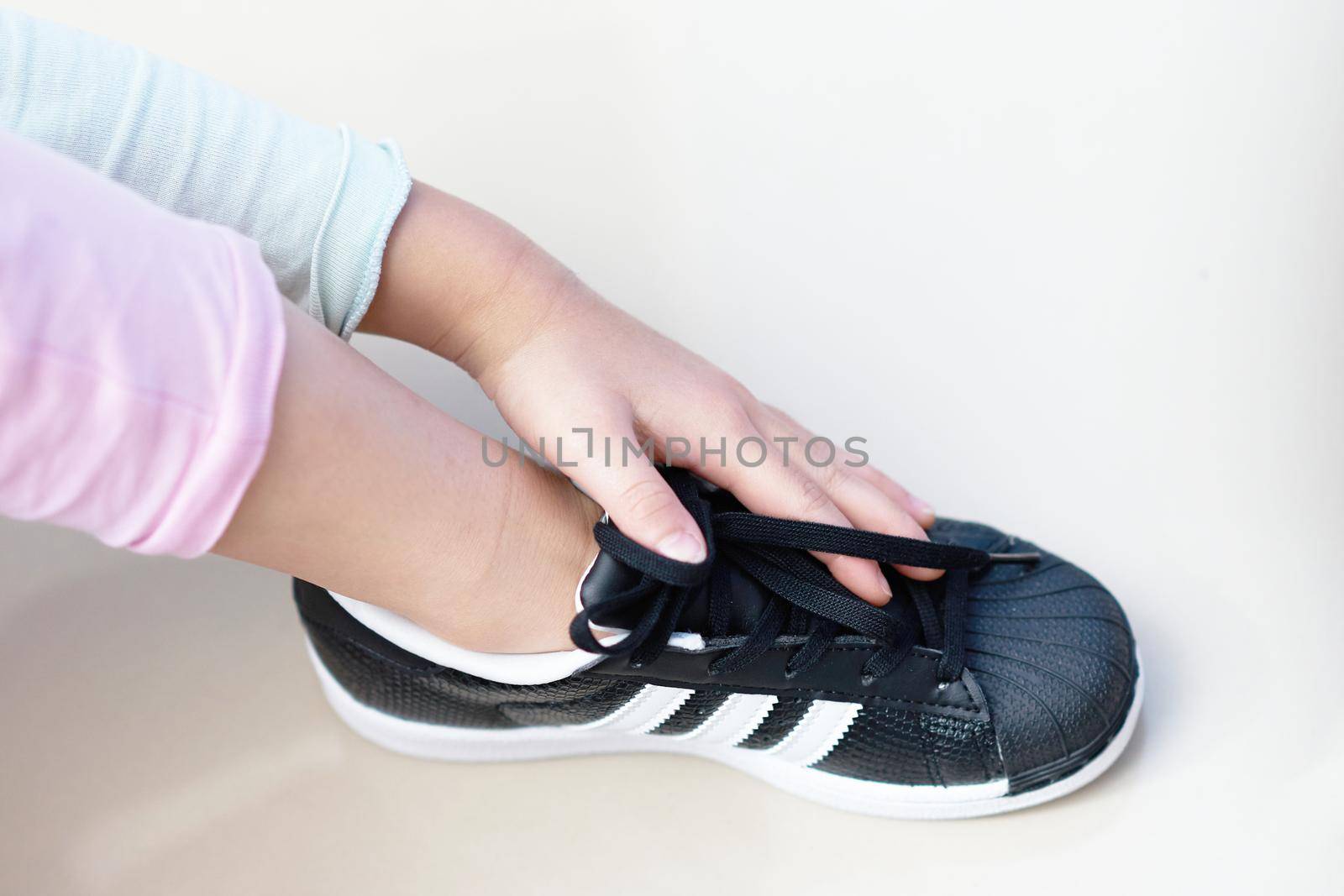 Bangkok ,Thailand,July 18 ,2018-kid hand touch adidas superstar shell toe originals sneaker shoe