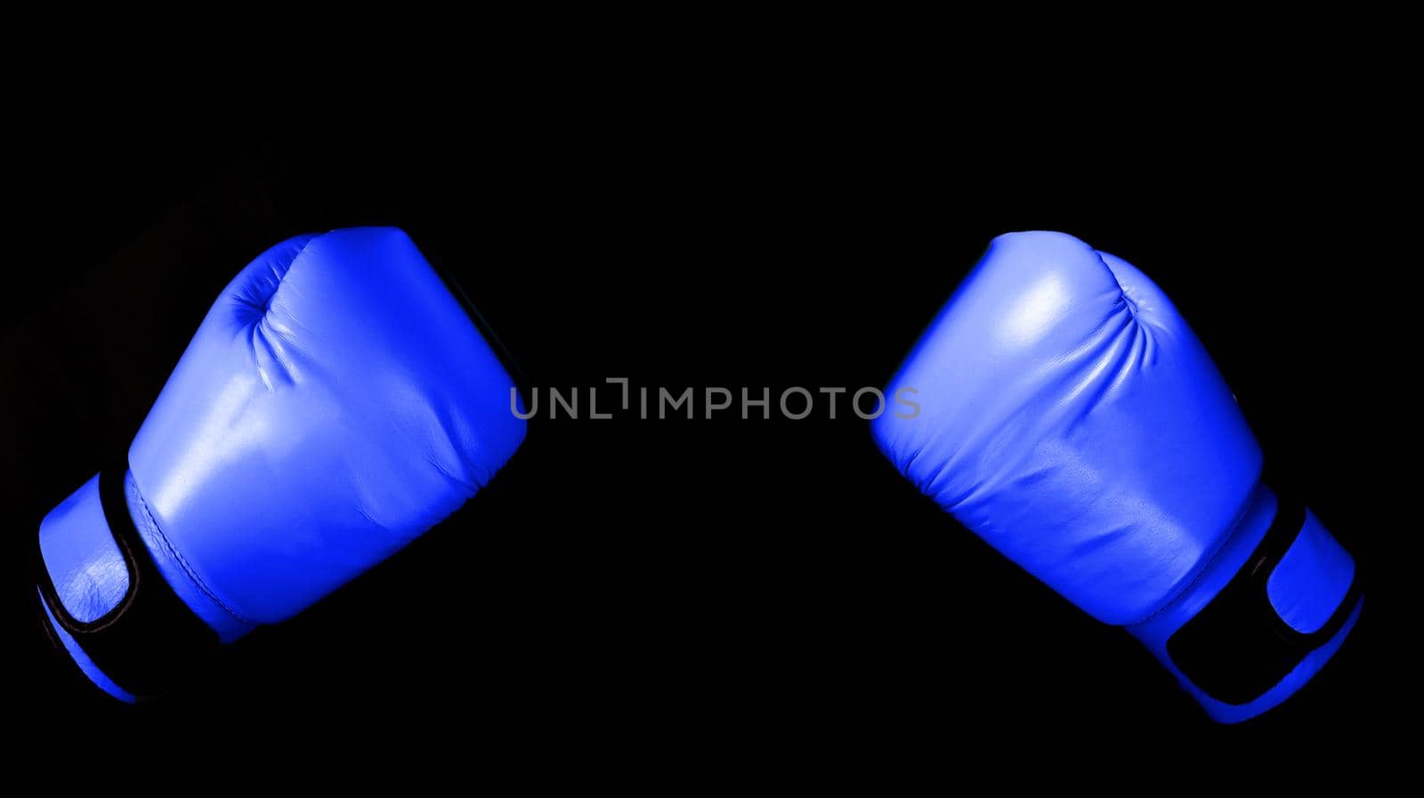 versus Boxing glove in punching  in black background with copy space