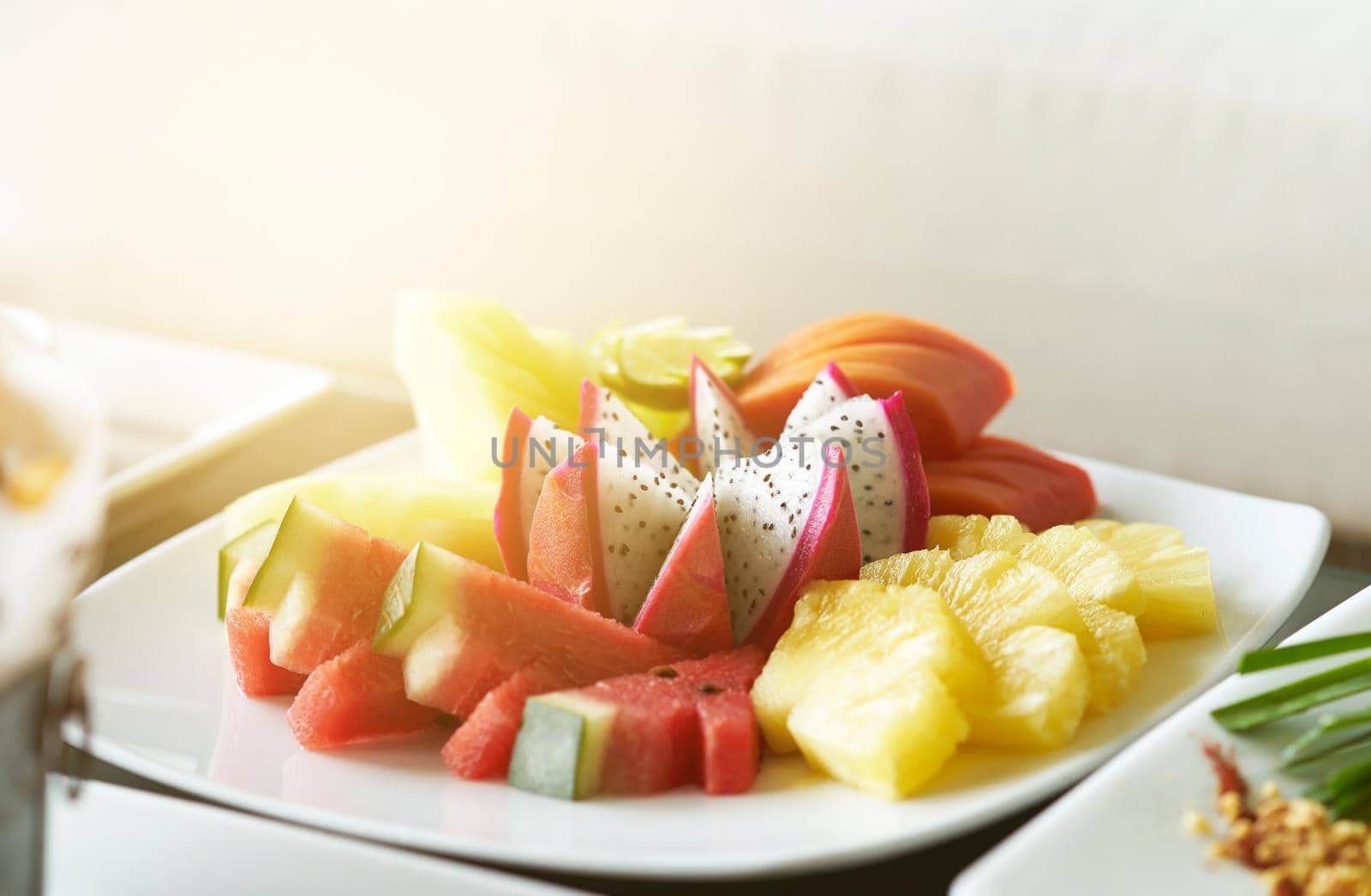 dragon fruit,pine apple,melon,water melon,papaya slice in plate for snack dessert