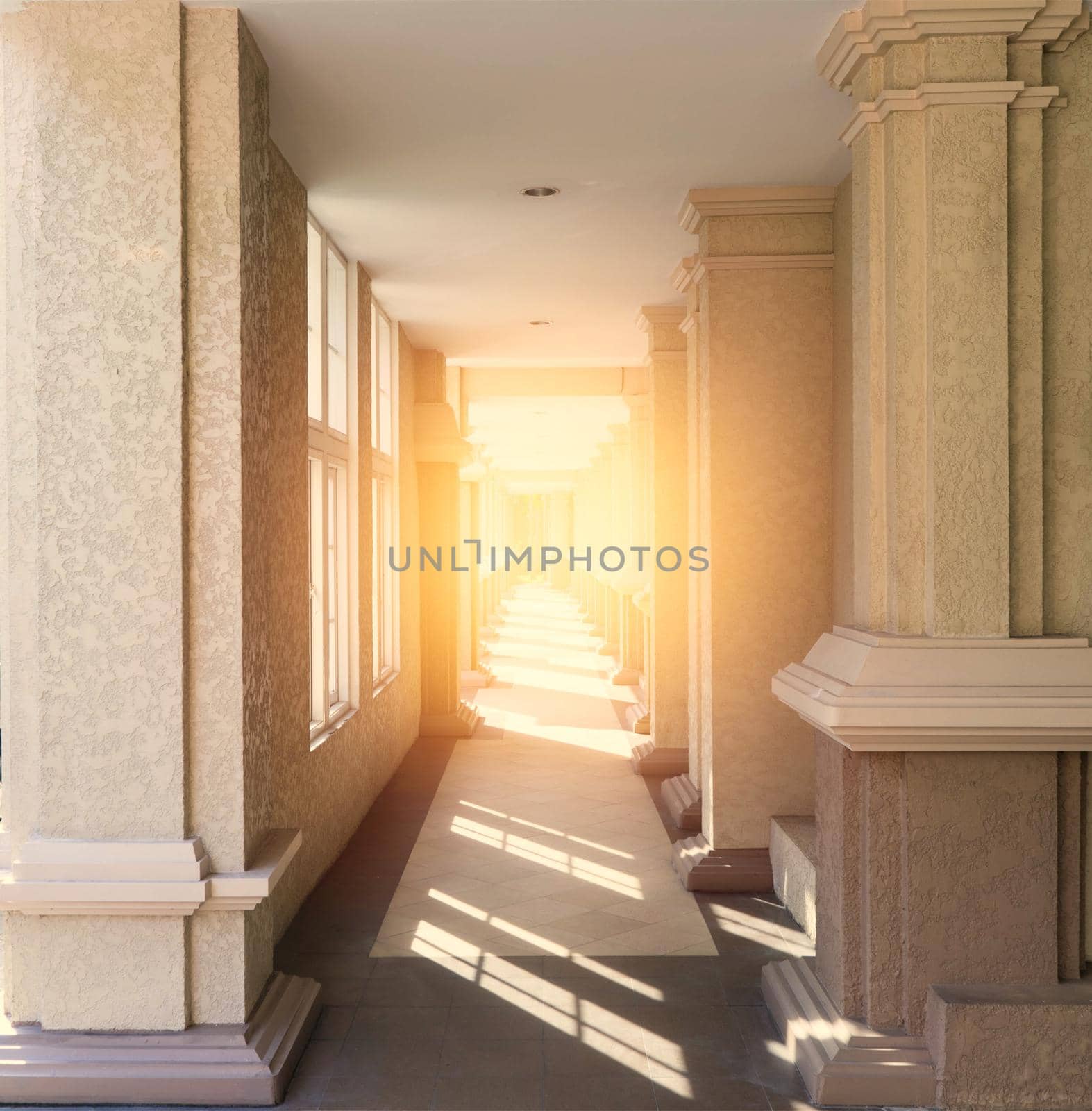 corridor of rectangle tunnel pillars with daytime sunlight in perspective
