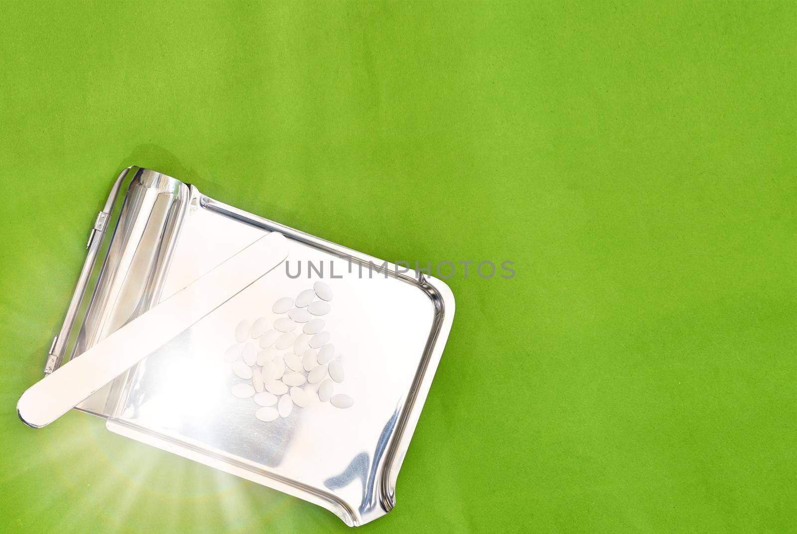 pills on tray on color background