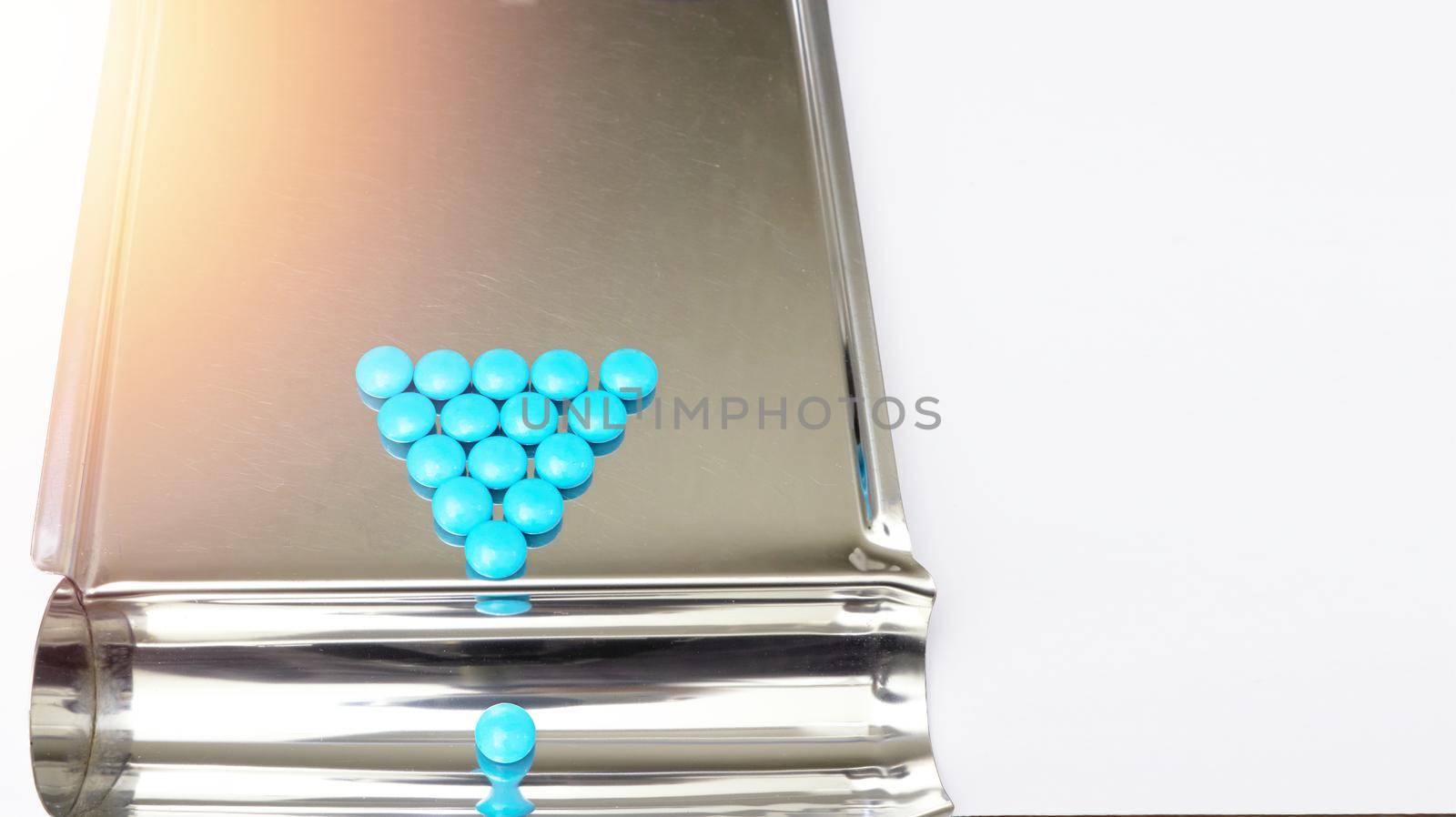 blue pill on pharmacy tray