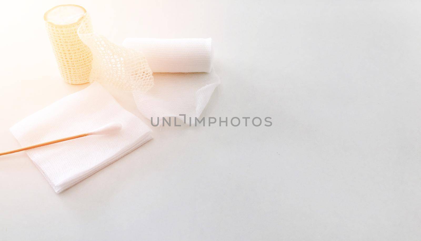 gauze bandage and jar on white