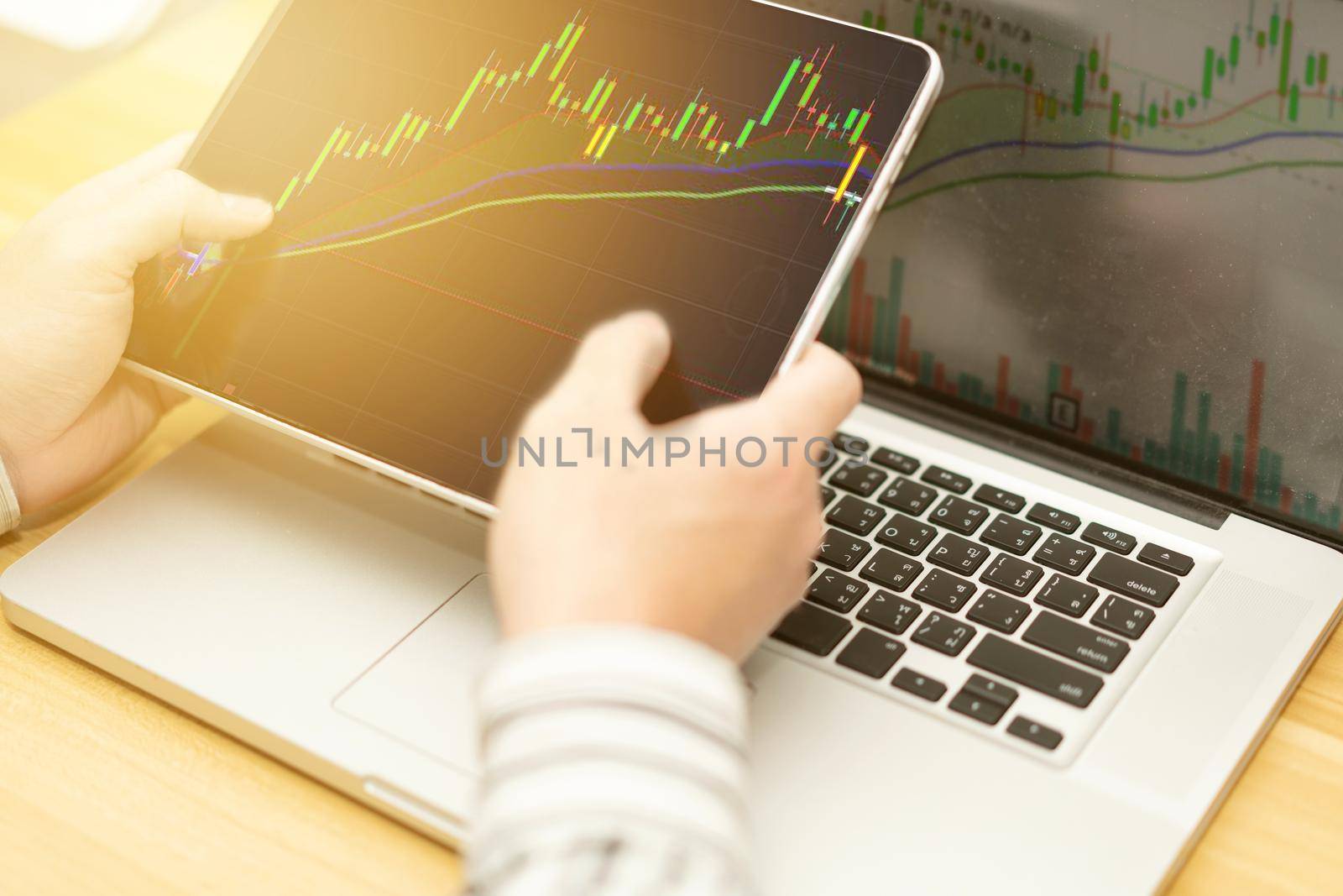 graph in computer and mobile show finance business and stock market volatility