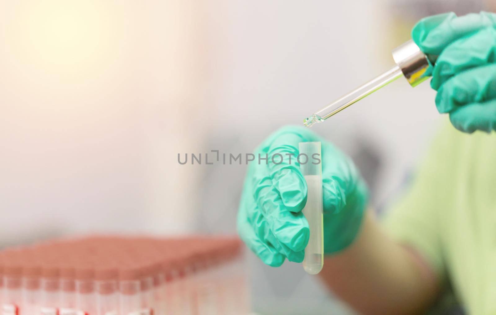 dropper in tube research in laboratory for chemistry research in medicine and biotechnology by VacharapongW