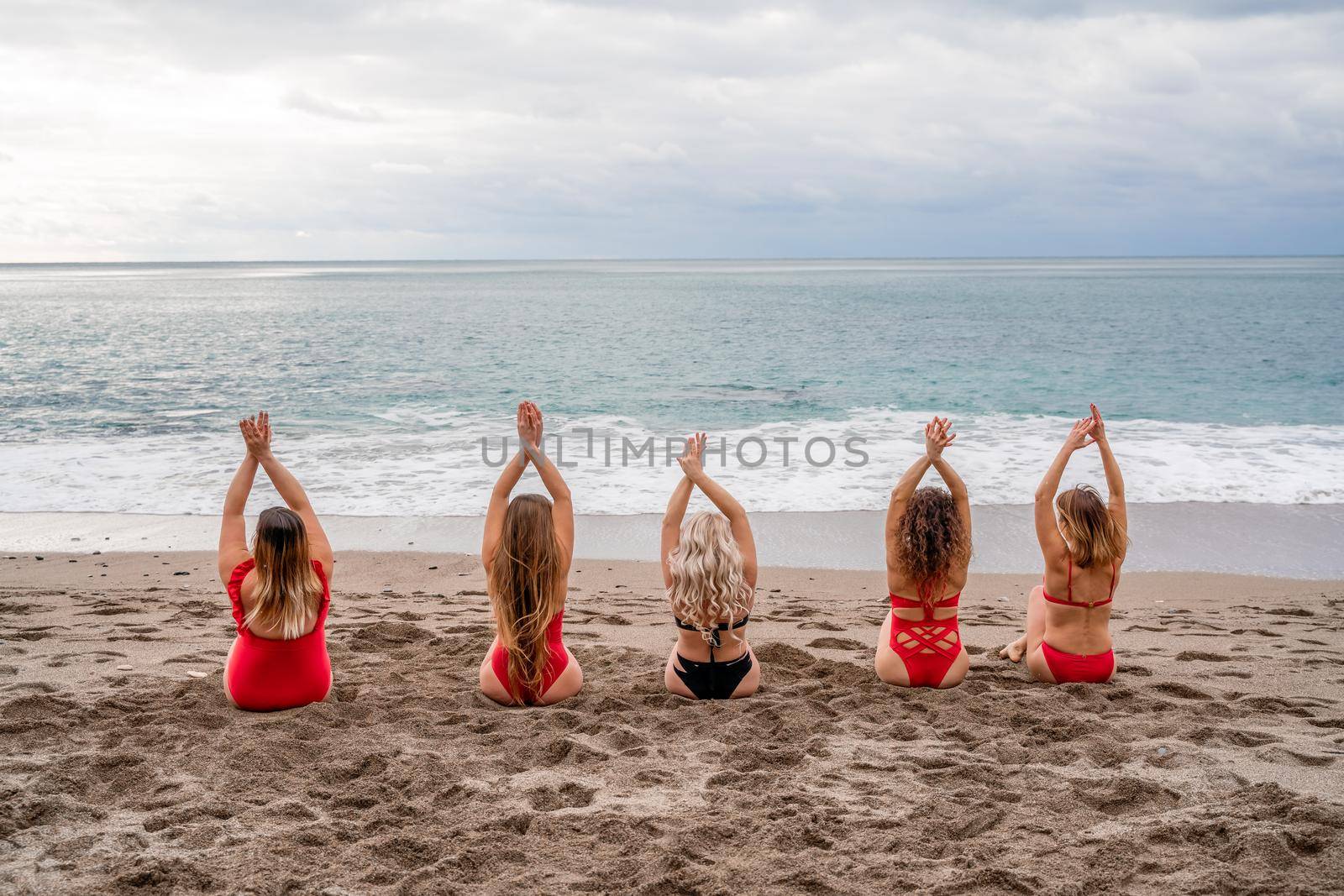 Big happy family or group of five friends is having fun against sunset beach. Beach holidays concept. by Matiunina