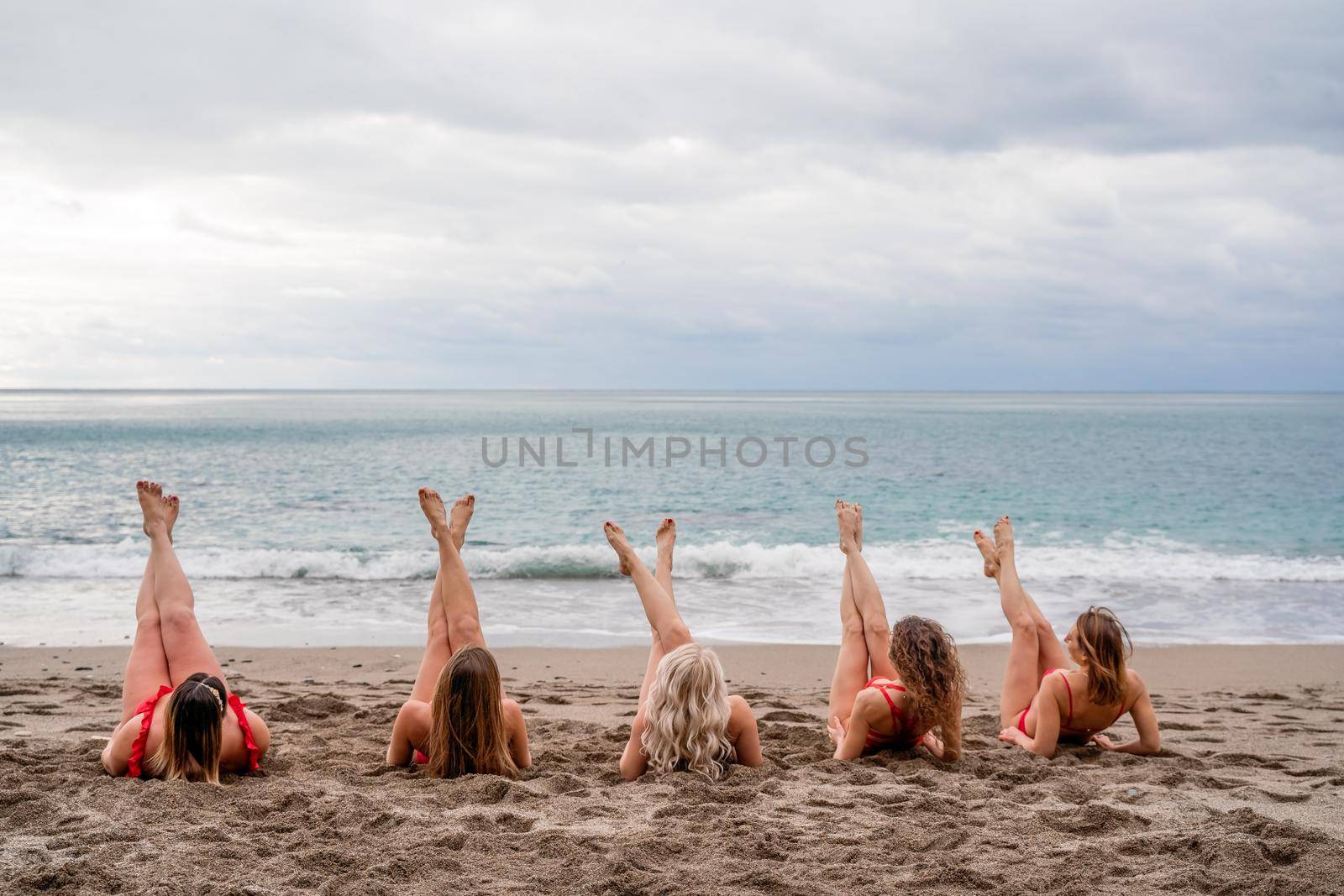 Big happy family or group of five friends is having fun against sunset beach. Beach holidays concept. by Matiunina