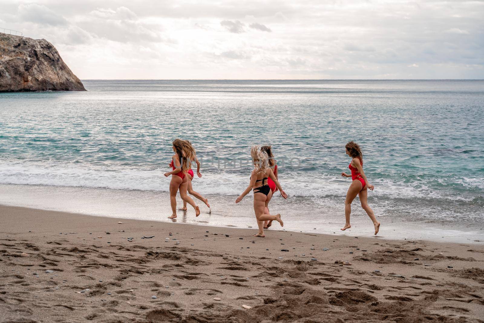 Big happy family or group of five friends is having fun against sunset beach. Beach holidays concept. by Matiunina