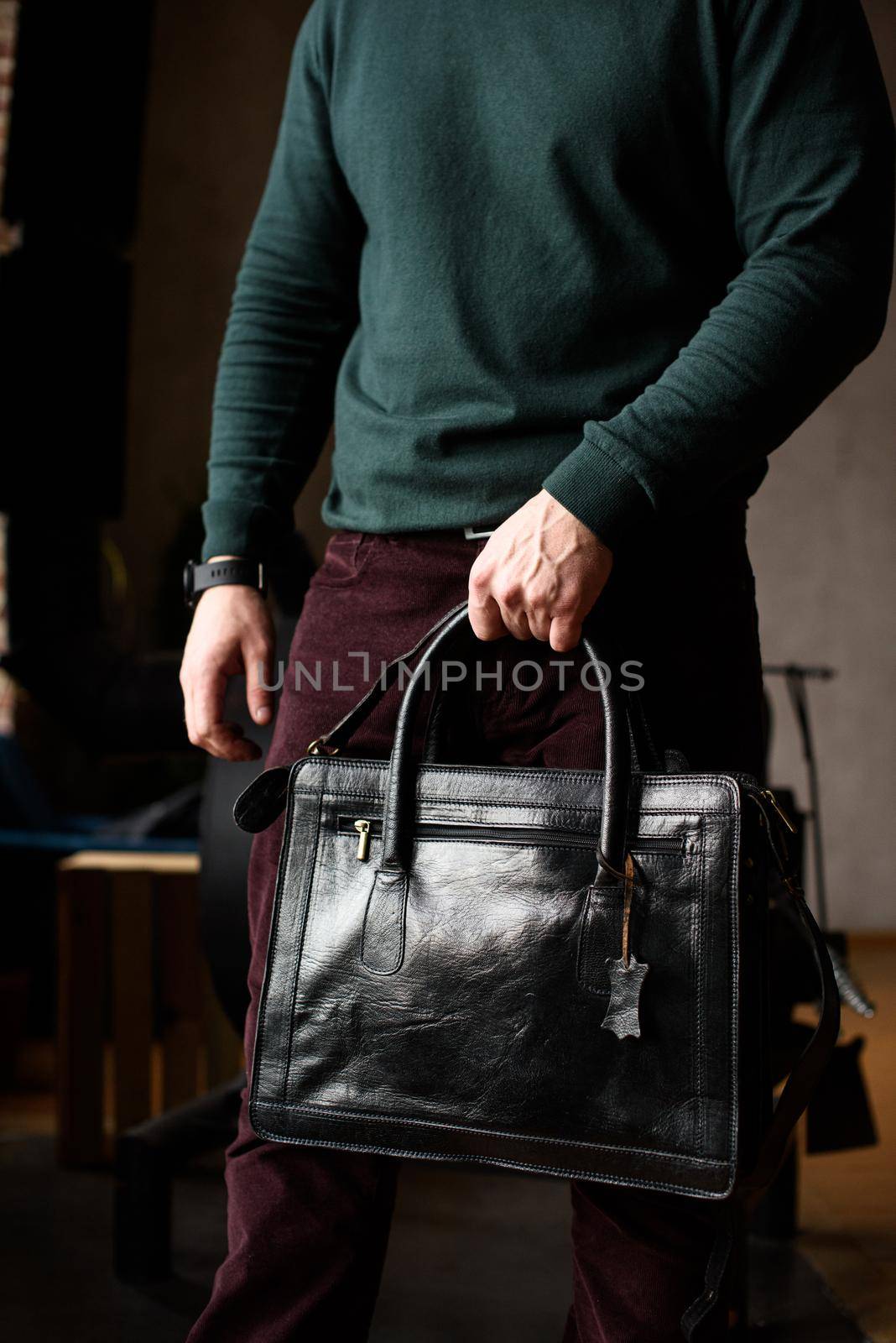 close-up photo of black leather bag in mans hands by Ashtray25