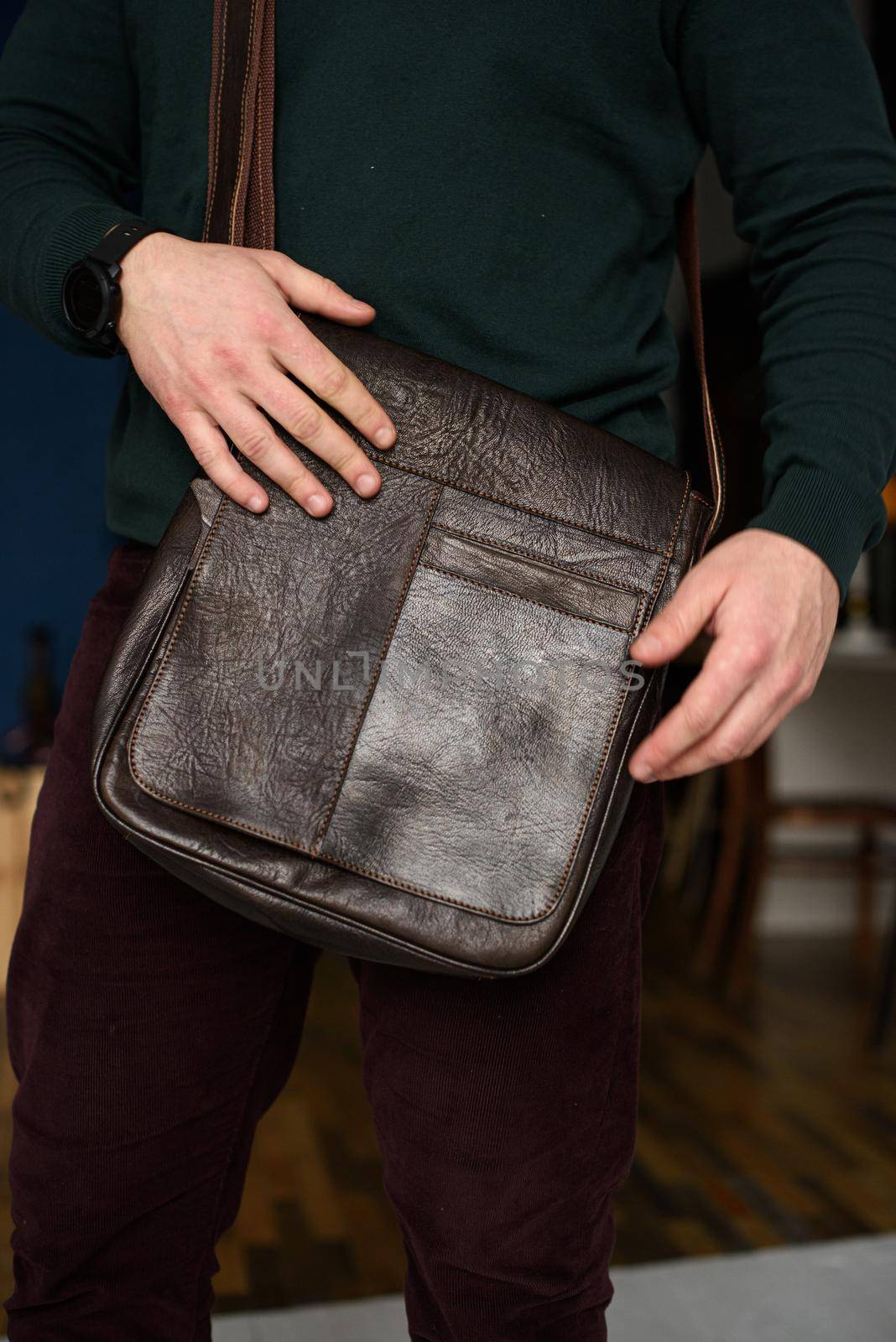 close-up photo of brown messanger leather bag on mans shoulder by Ashtray25