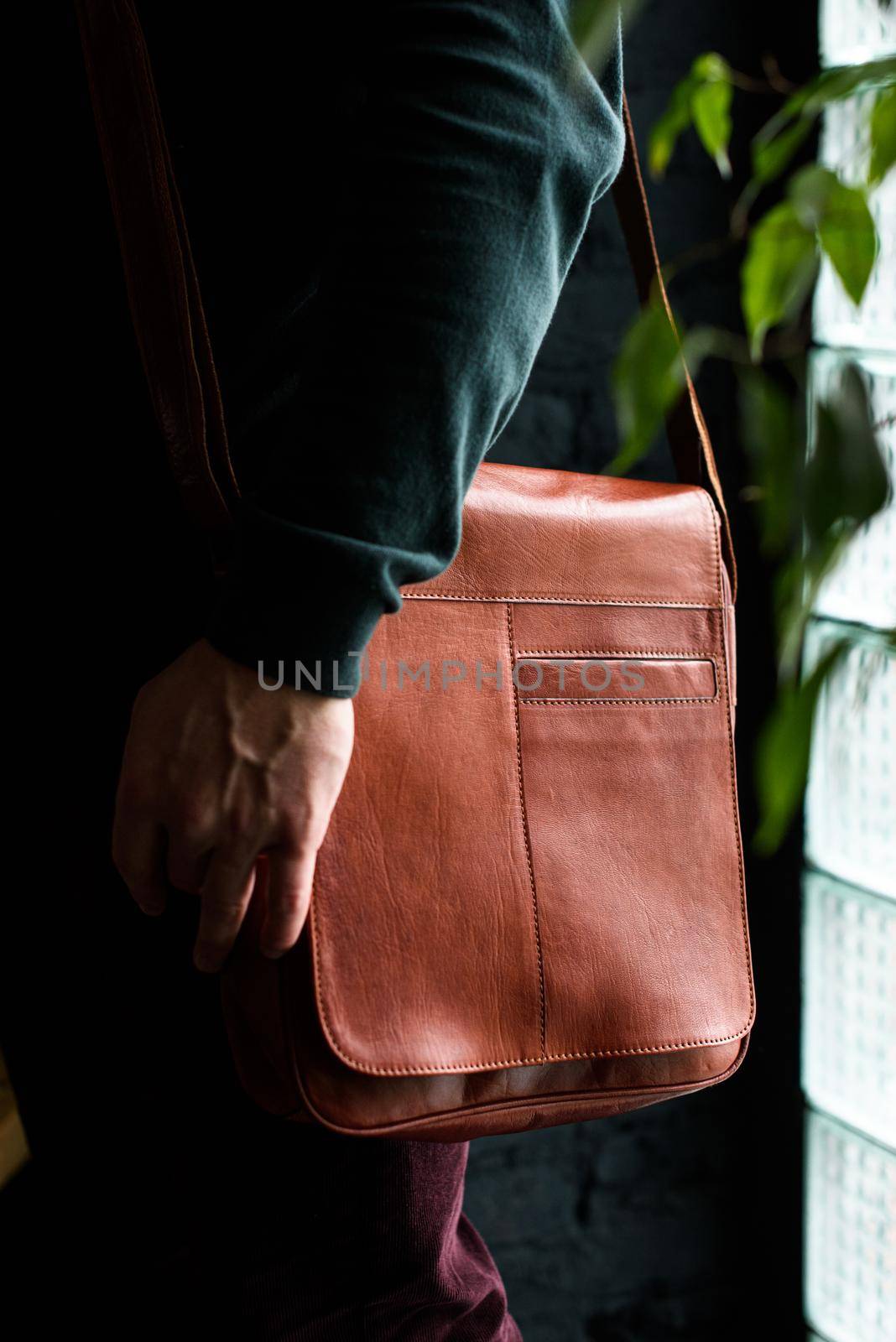 close-up photo of orange leather bag on mans shoulder by Ashtray25