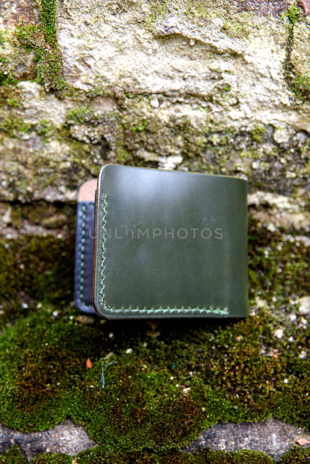 hand made green leather wallet . Leather craft. Selective focus by Ashtray25