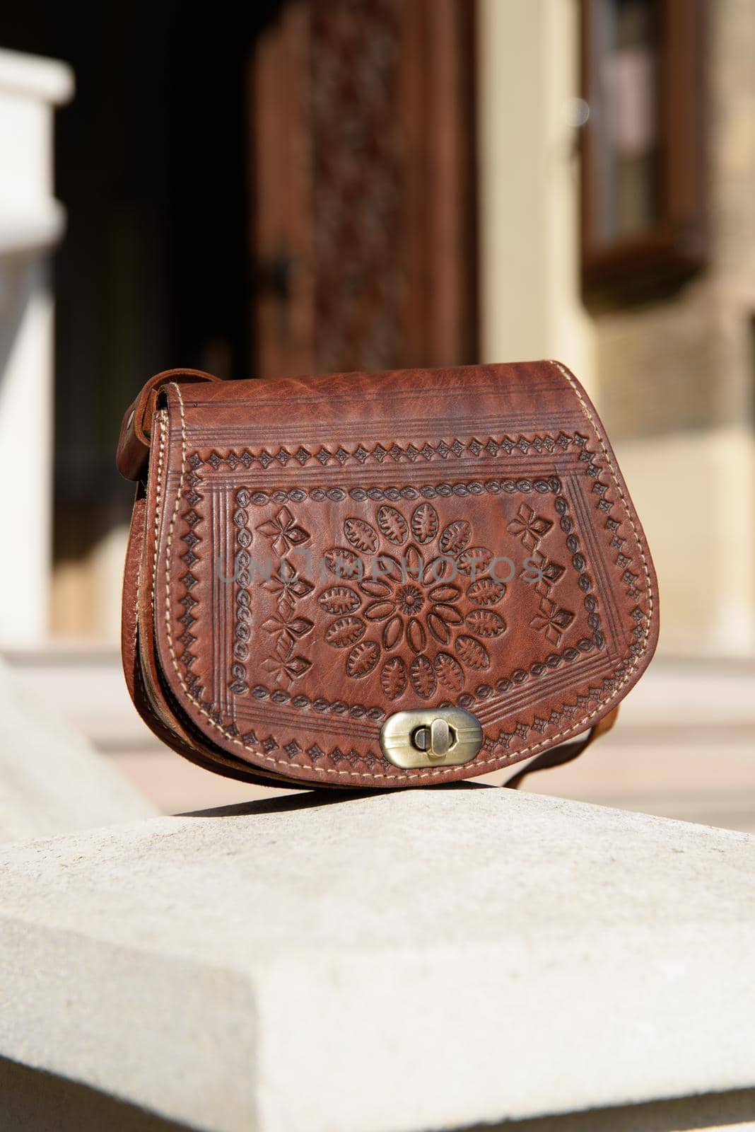 small brown women's leather bag with a carved pattern by Ashtray25