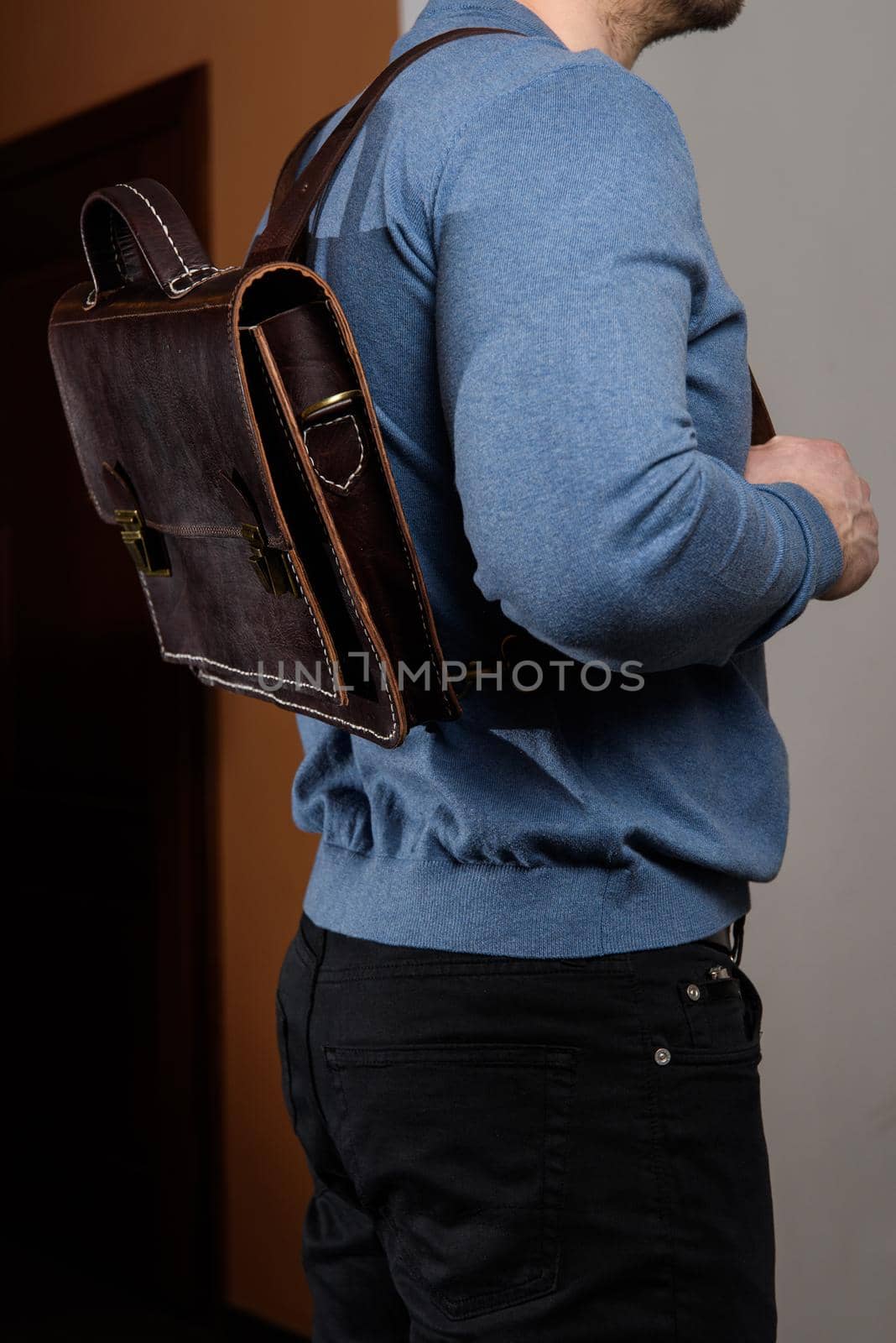 Back of man in a blue sweater with brown leather backpack. Unisex bag for sale. by Ashtray25