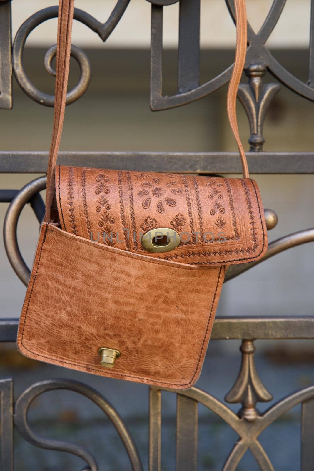 small yellow women's leather bag with a carved pattern. street photo