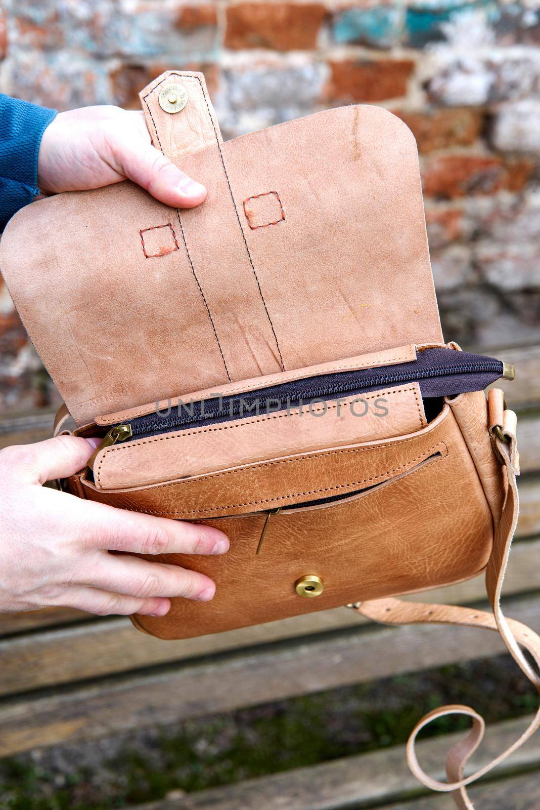 close-up photo of yellow leather handbag. Outdoors photo