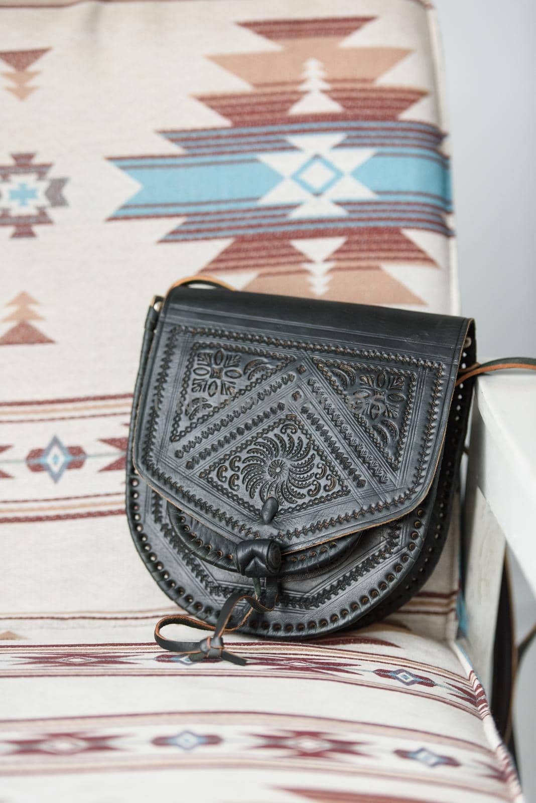 small black women's leather bag with a carved pattern. selective focus by Ashtray25