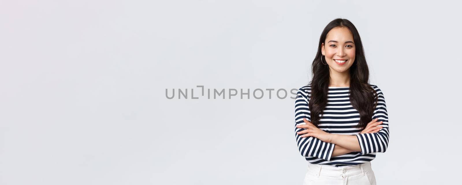 Lifestyle, people emotions and casual concept. Confident nice smiling asian woman cross arms chest confident, ready to help, listening to coworkers, taking part conversation.