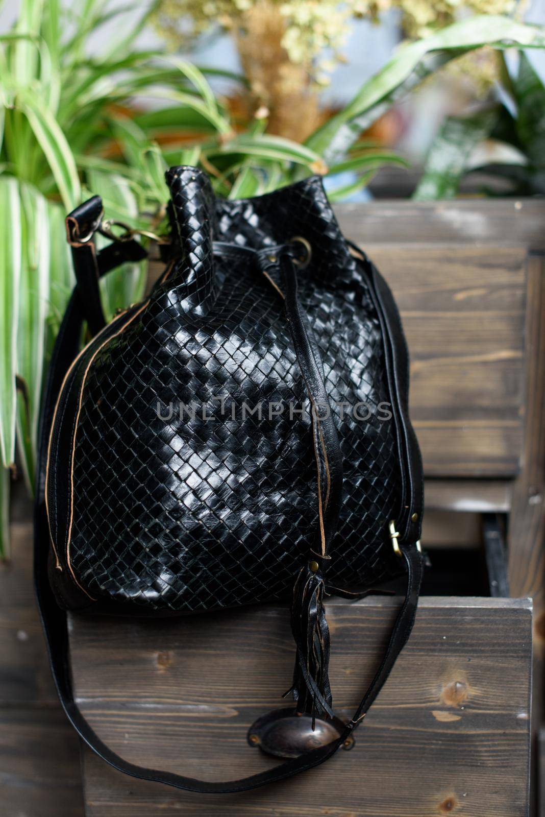 brown leather backpack on the vintage armchair.