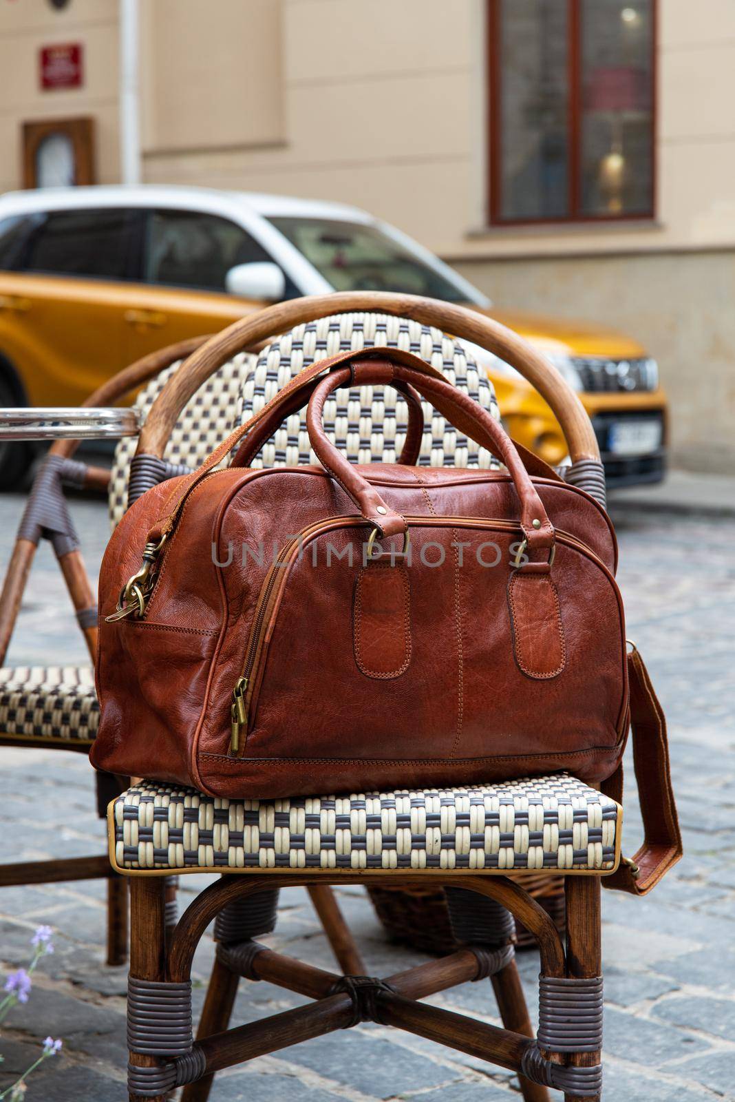 close-up photo of brown leather bag corporate. street photo