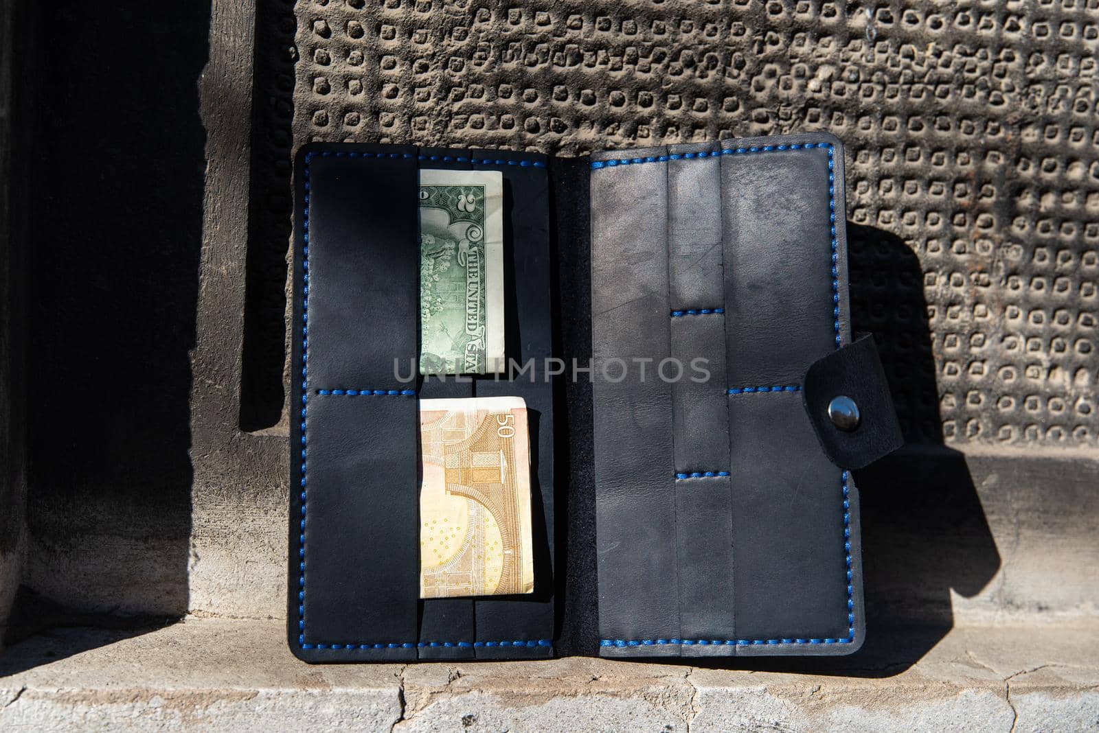 hand made leather wallet . Leather craft. Selective focus by Ashtray25