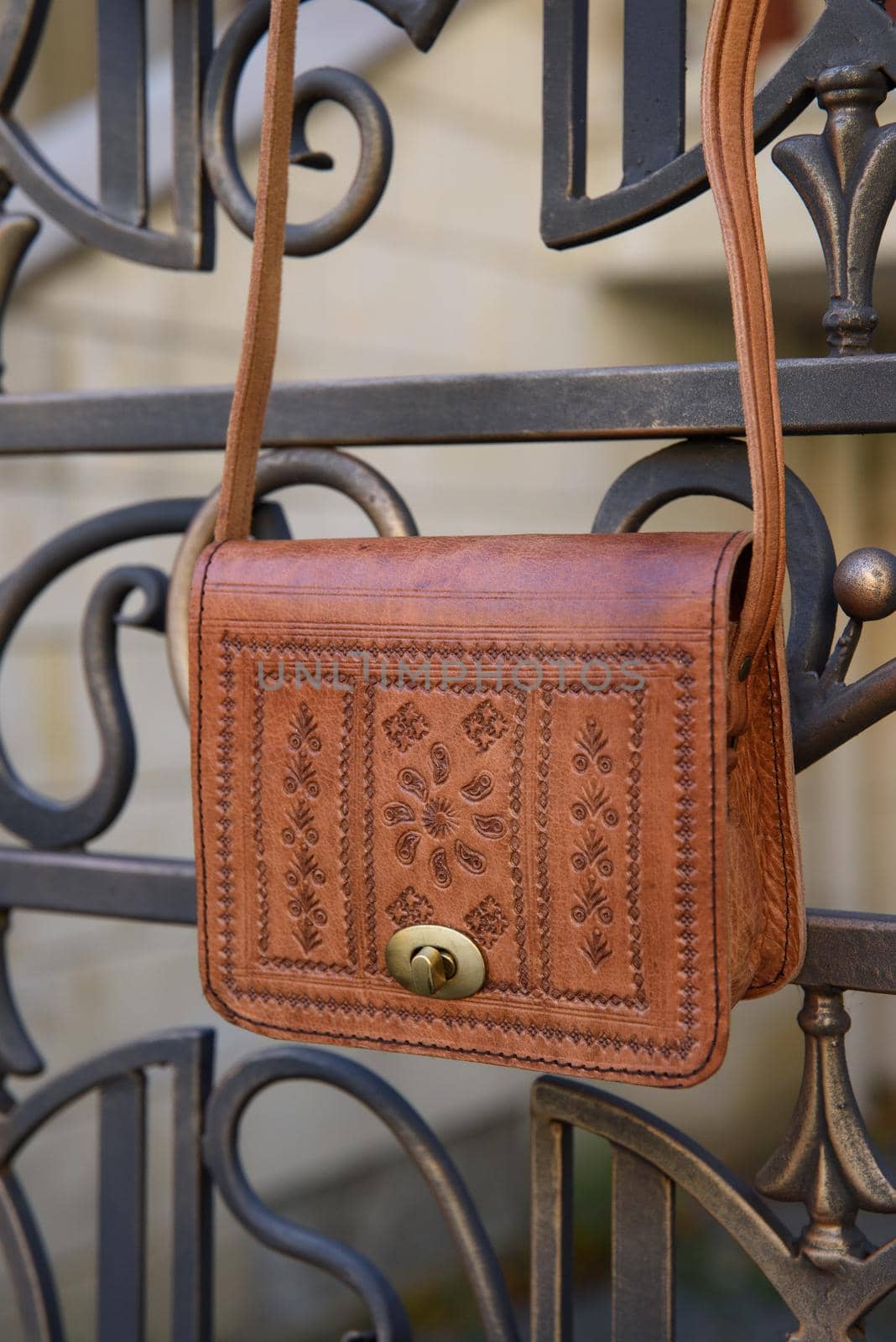 small yellow women's leather bag with a carved pattern. street photo