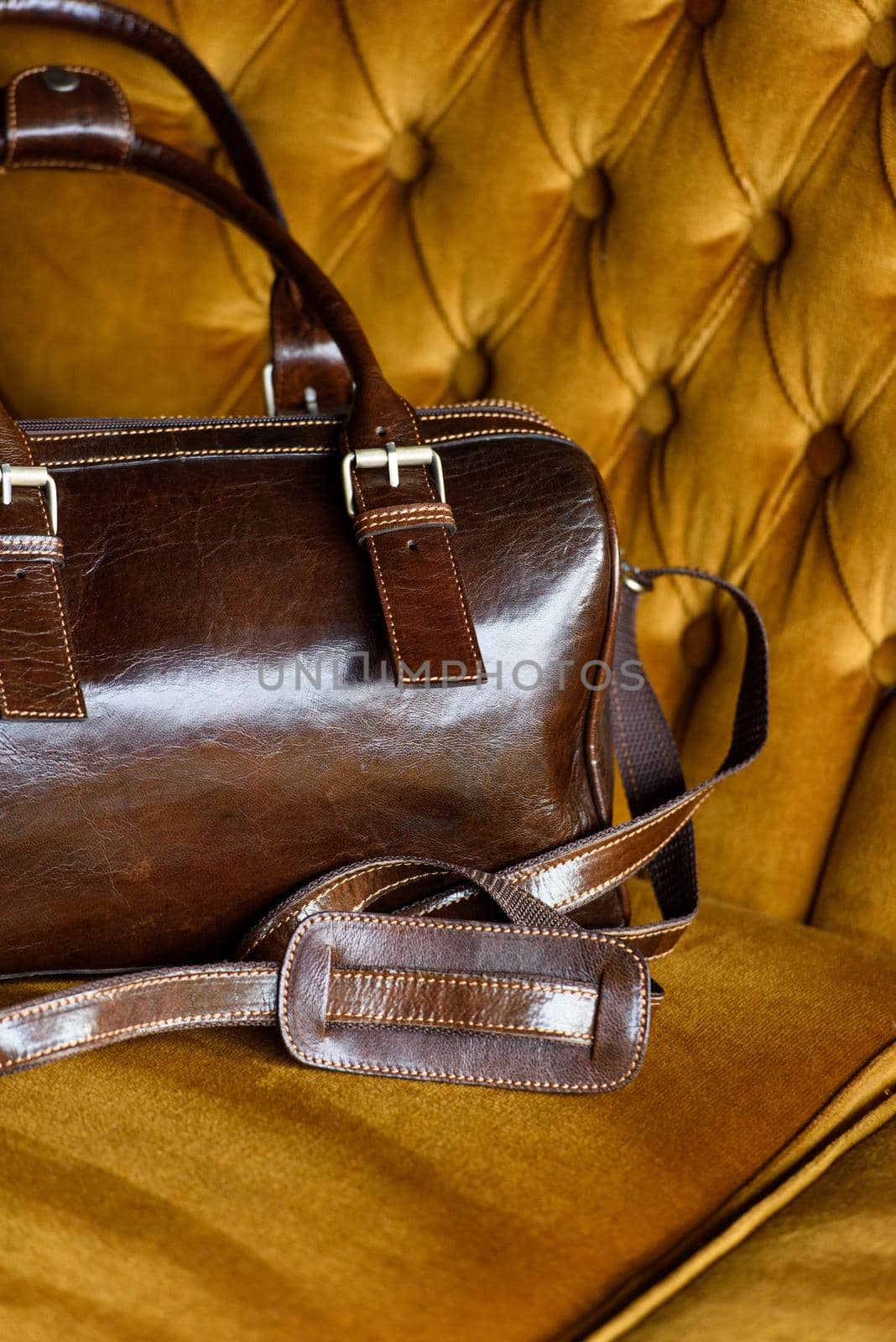 close-up photo of brown leather bag on a vintage sofa. indoor photo