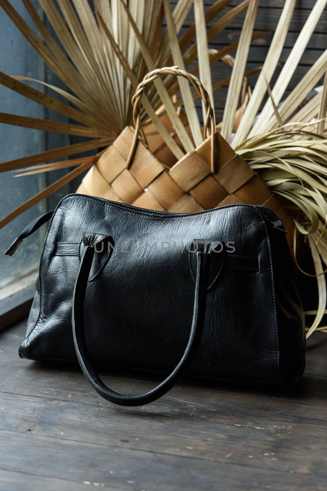 close-up photo of black leather bag on a wooden table. indoor photo