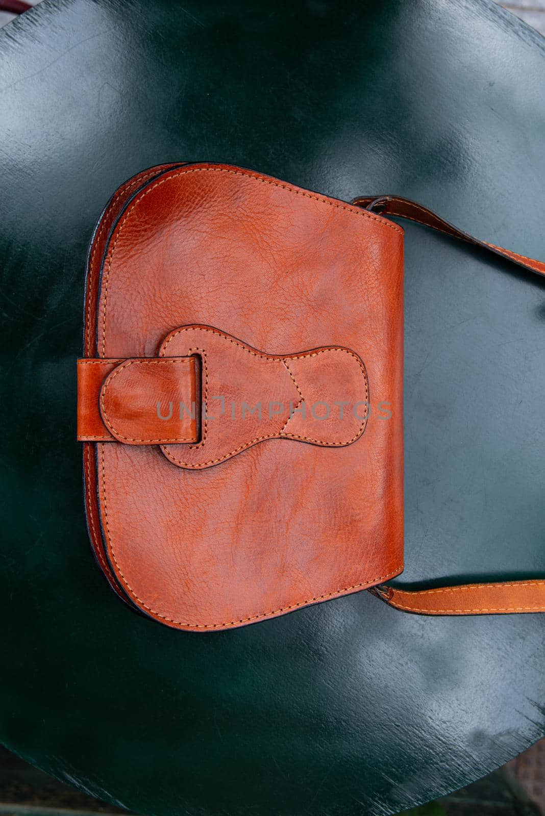 small orange women's leather bag . street photo