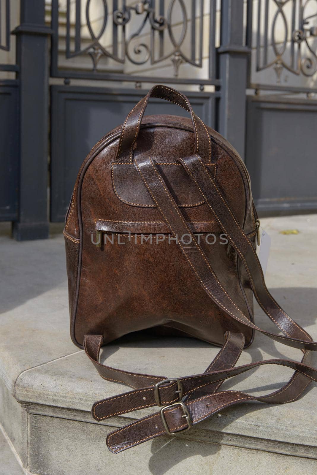 Brown leather backpack on the snone monument.