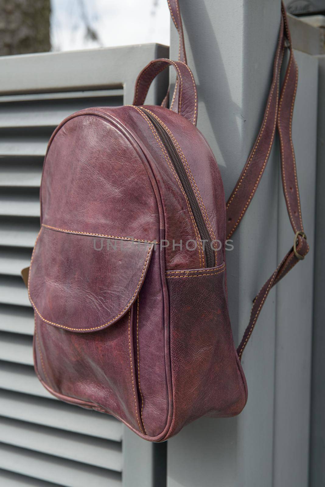 burgundy leather backpack on the metal fence by Ashtray25