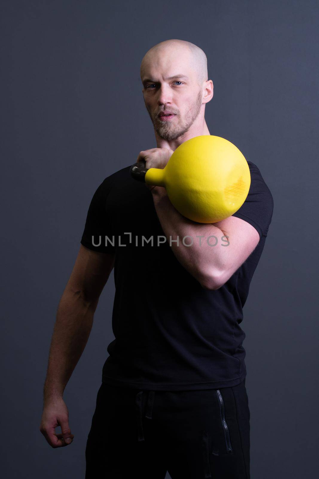 Guy with a yellow kettlebell gym anonymous workout male, in the afternoon motivation lifestyle for strong and resitance sportswear, malaysian filipino. Guy bent endurance, building hiit