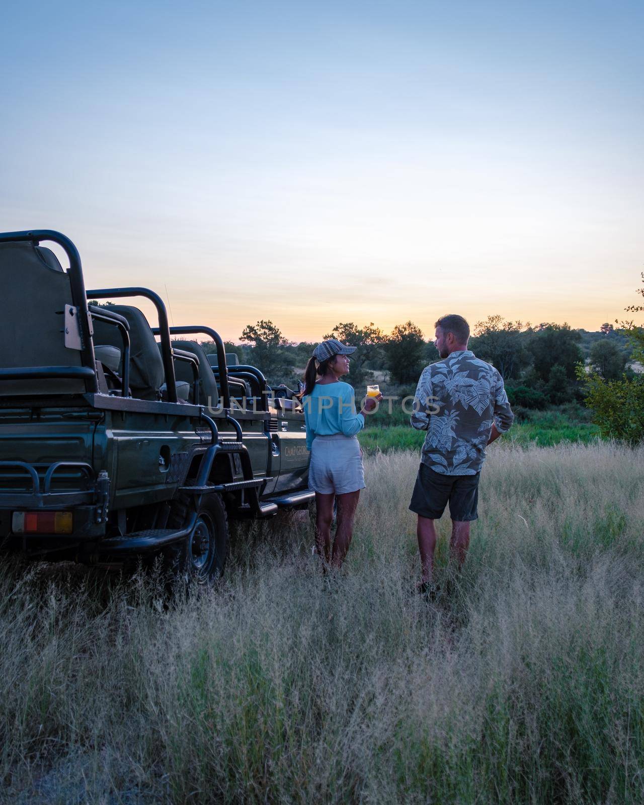 South Africa, luxury safari car during game drive, couple men and woman on safari in South Africa by fokkebok