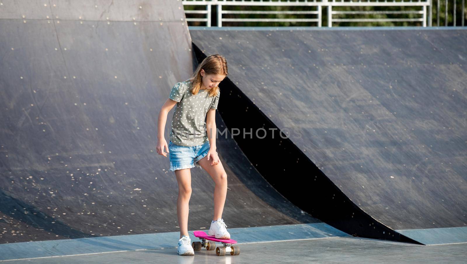 Girl with skateboard outdoors by tan4ikk1