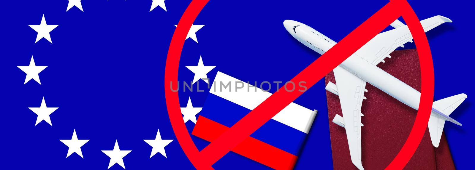 Russian flag, toy plane and barbed wire on blue background, concept of banning aircraft departing from Russia. by Andelov13
